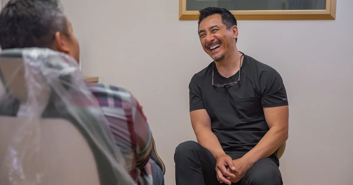 Dr. Kuzi Hsue, DDS consulting with a dental implant patient at West Valley Dental