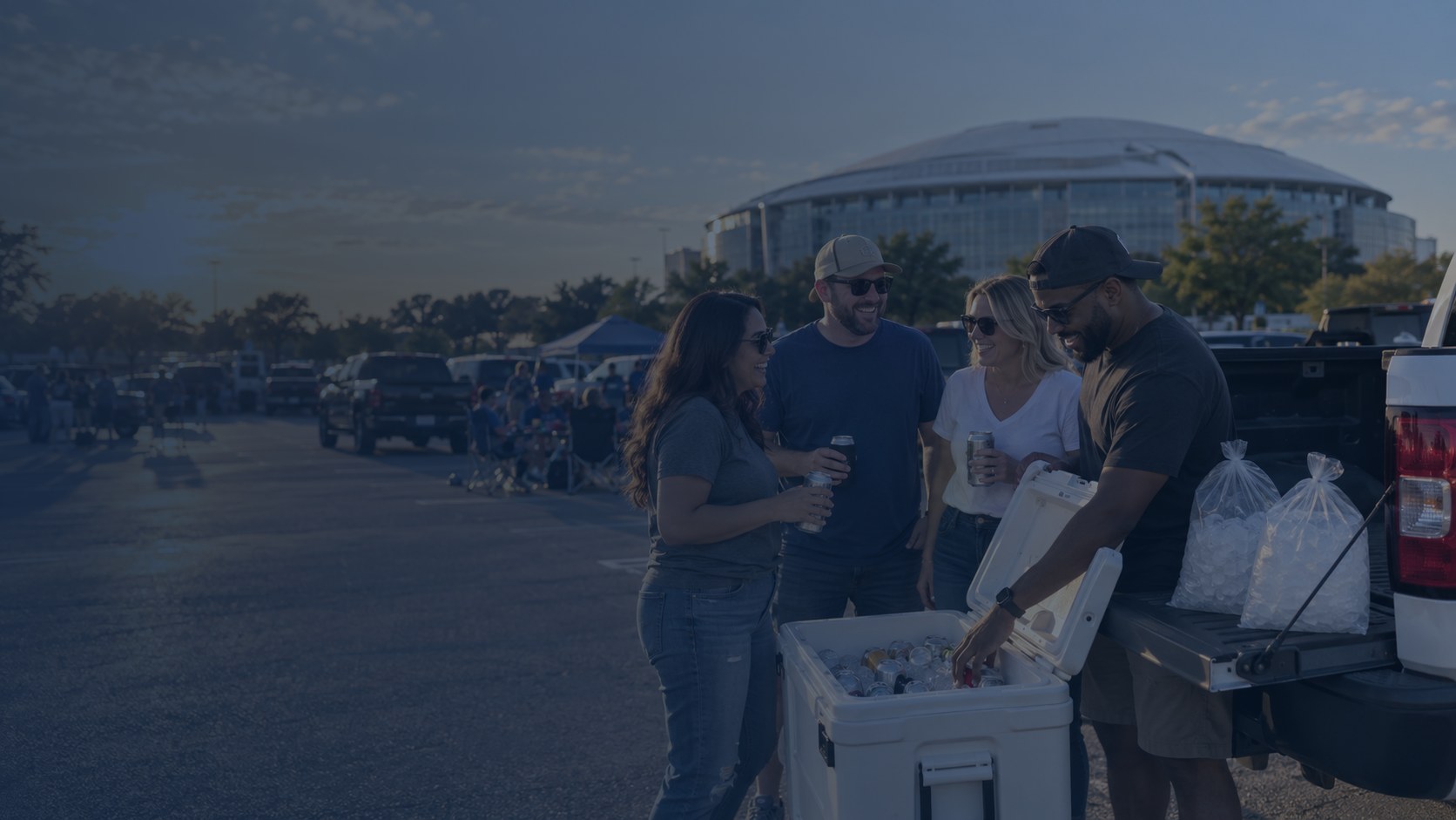 Tailgate crew outside AT&T Stadium in Arlington with coolers stocked with bagged ice and cold drinks