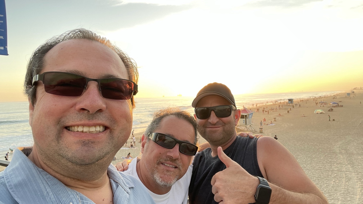 Mike Trelles with friends enjoying the beach and coastal golden hour in Huntington Beach