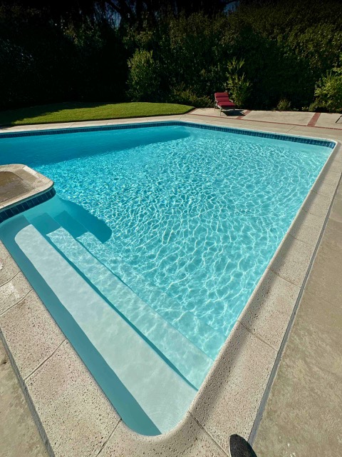 Rectangular in-ground pool with shallow steps and clear surface