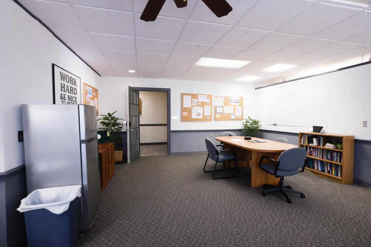 The conference table, whiteboard, and workspace room at FlexDeskery