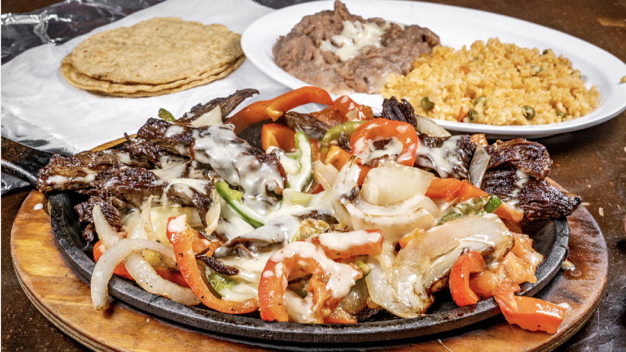 Sizzling steak and vegetable platter at La Piñata Mexican Grill