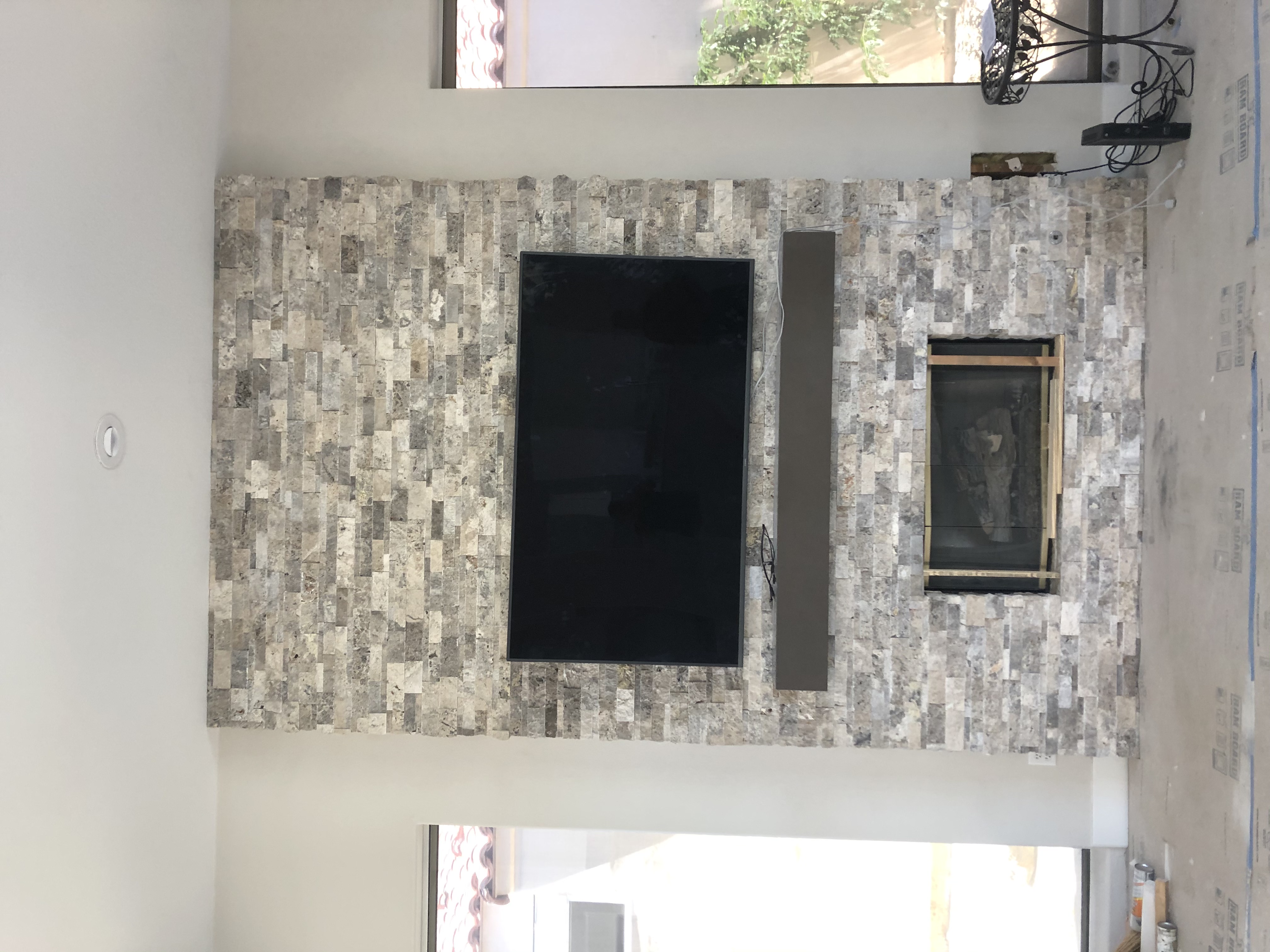 Stacked Stone Fireplace & Media Wall project by Davenport Tile