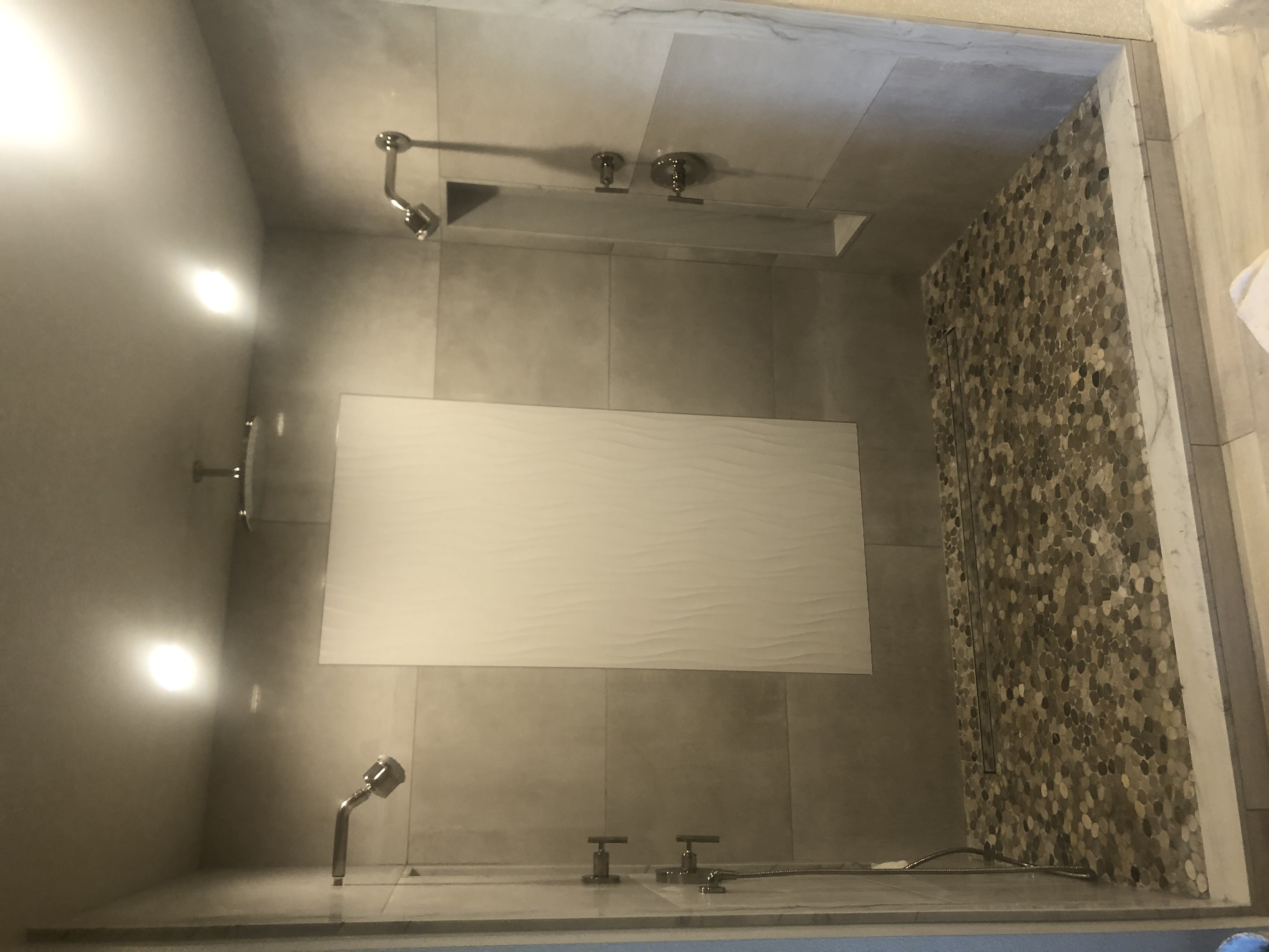 Dual Shower Suite with Pebble Floor project by Davenport Tile