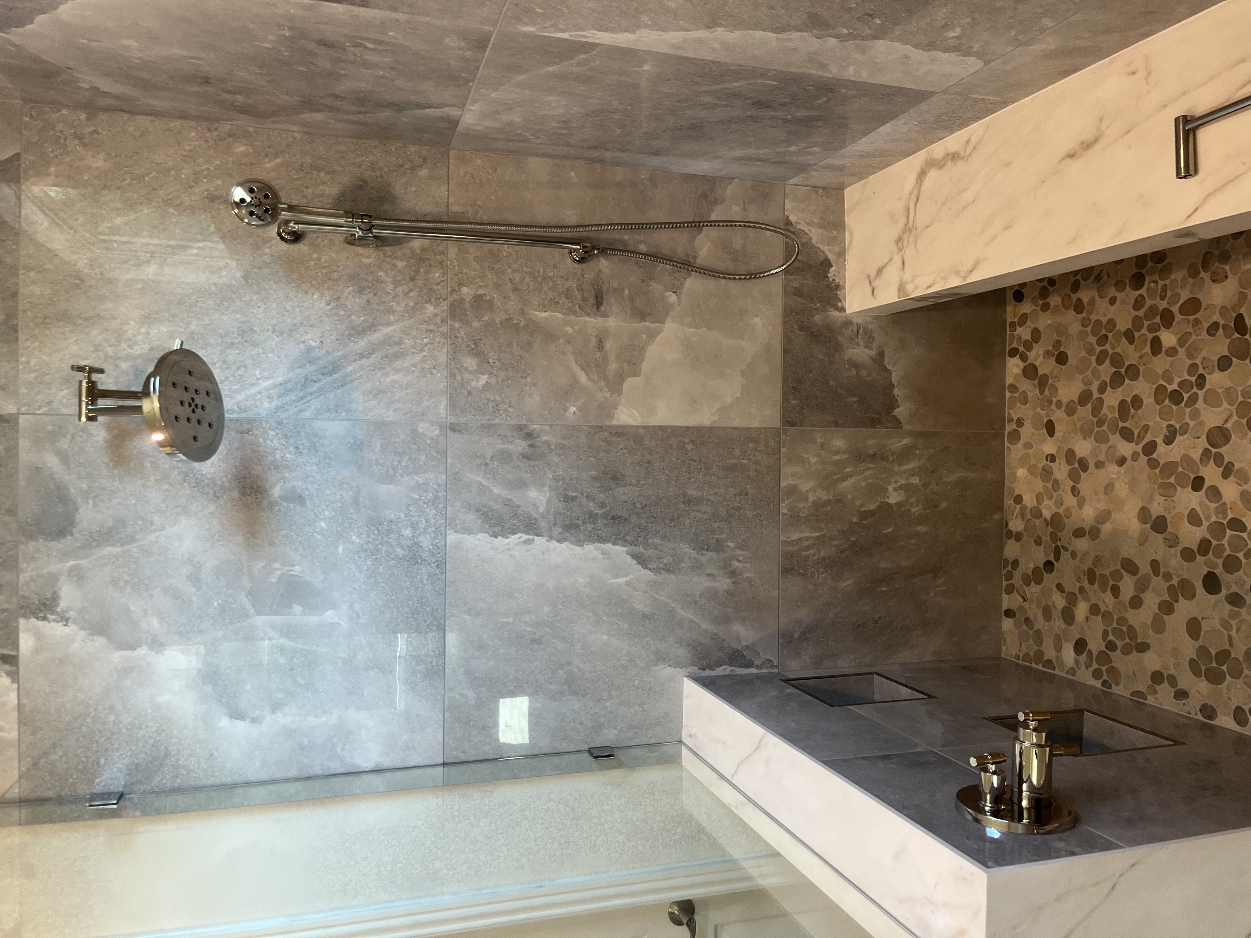Custom Marble Ledge & Dual Shower Detail project by Davenport Tile