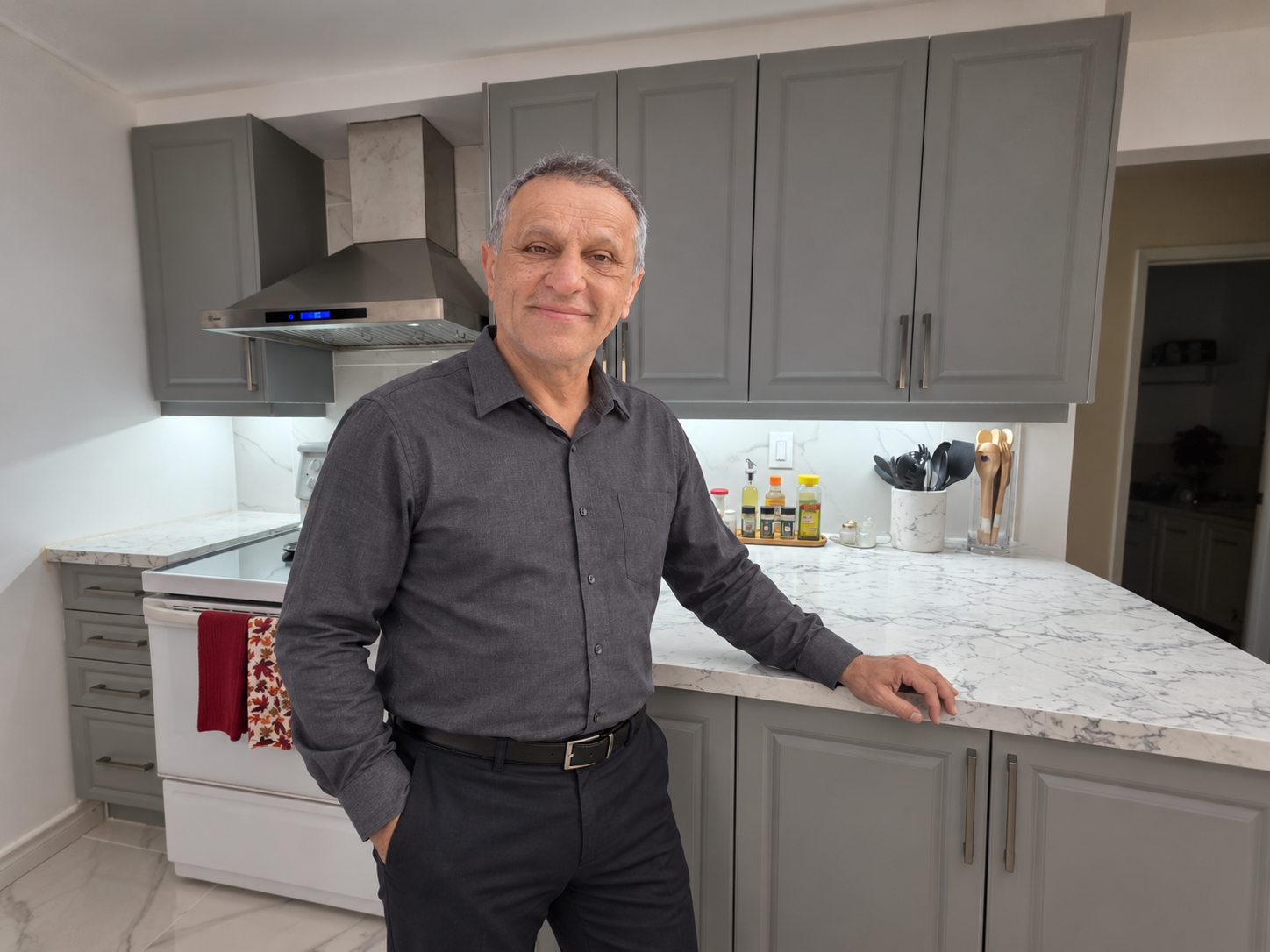 Ideal Countertop founder and craftsman in a newly completed kitchen with custom stone countertops