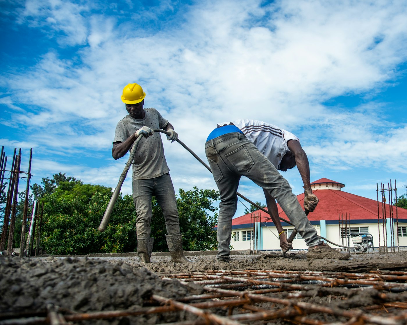 Concrete contractor pouring and finishing driveway
