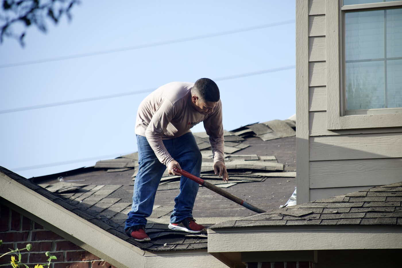 Roofing contractor working on roof installation