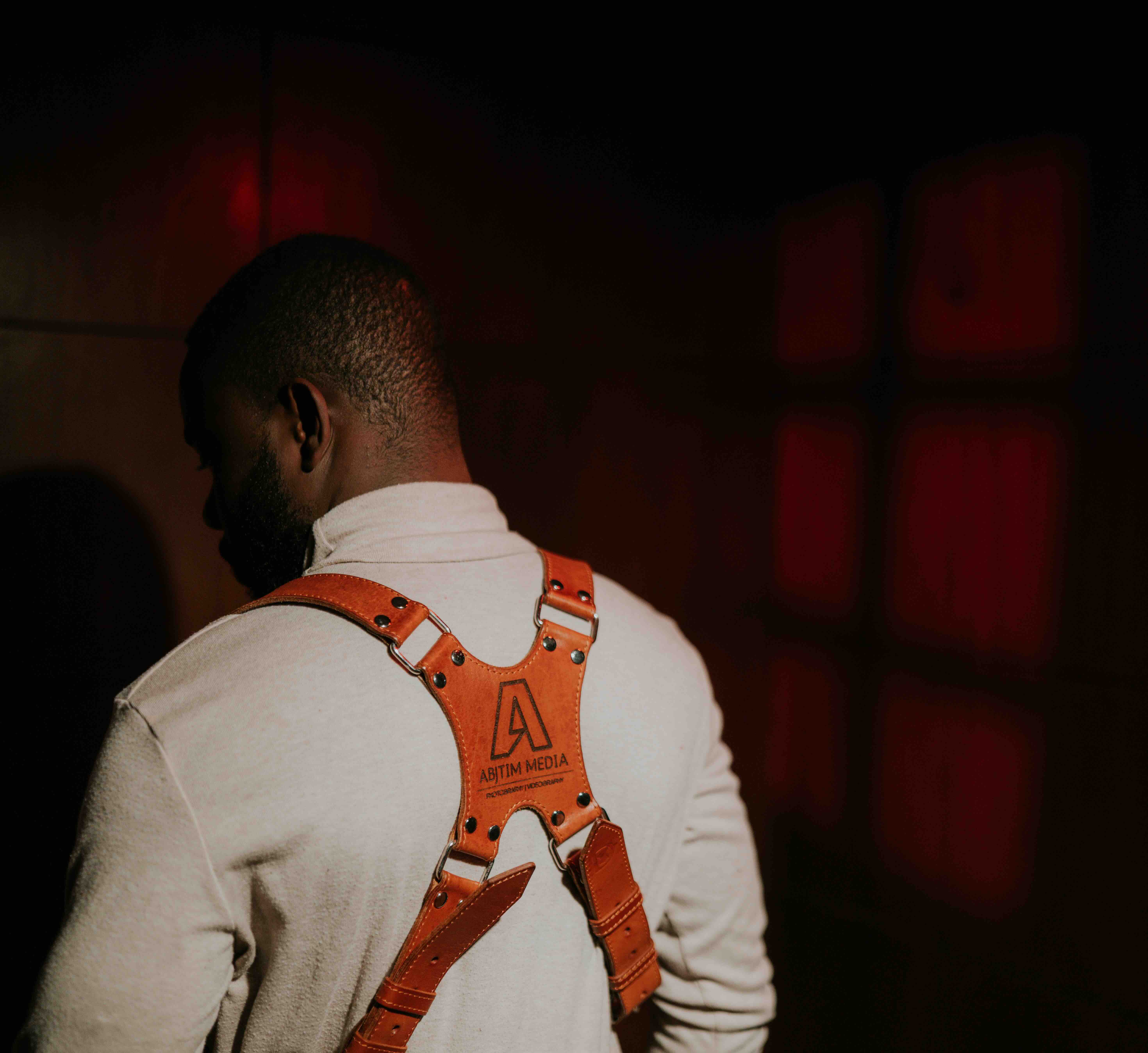 Abraham wearing ABJTIM MEDIA branded leather camera harness