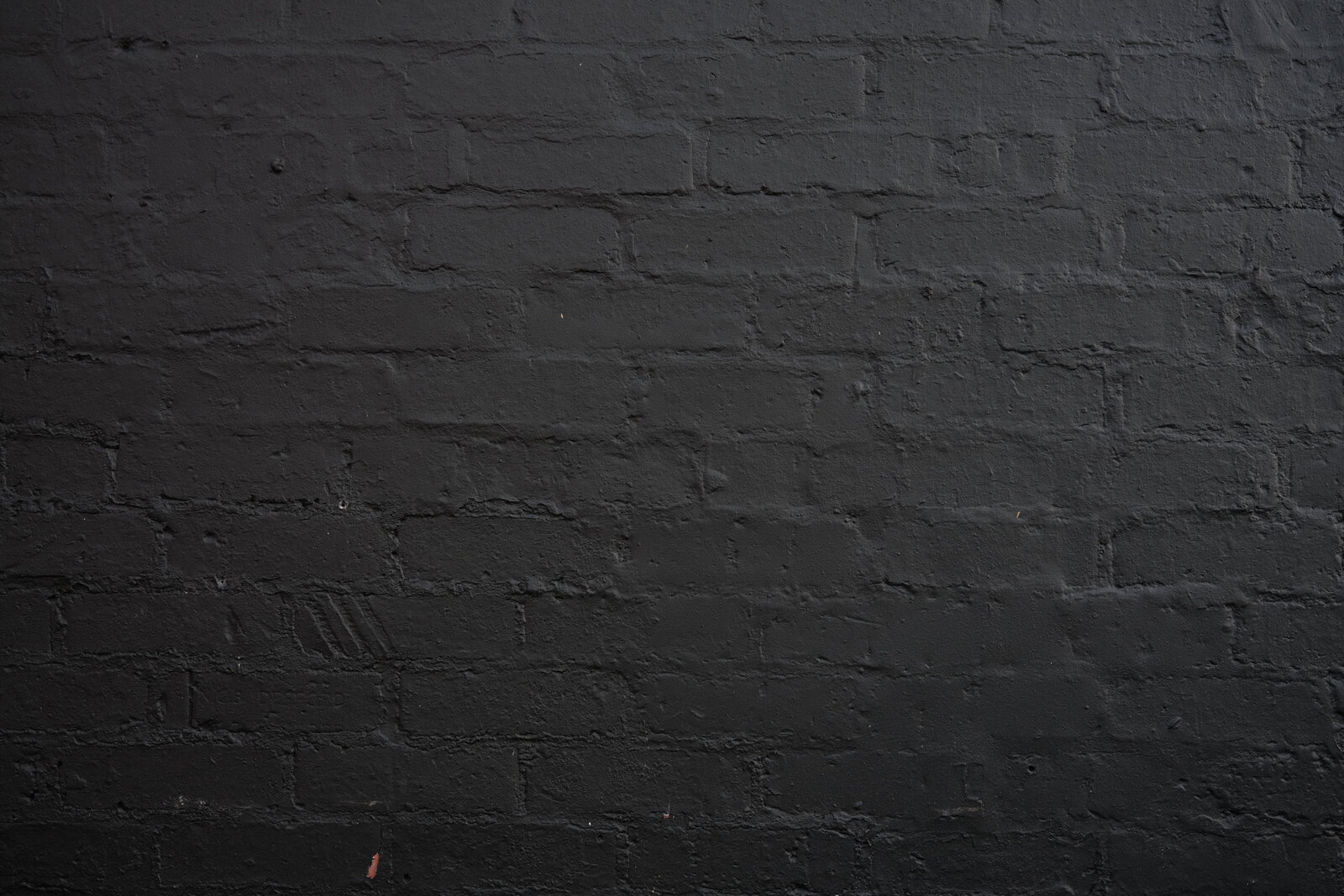Dark painted brick wall texture
