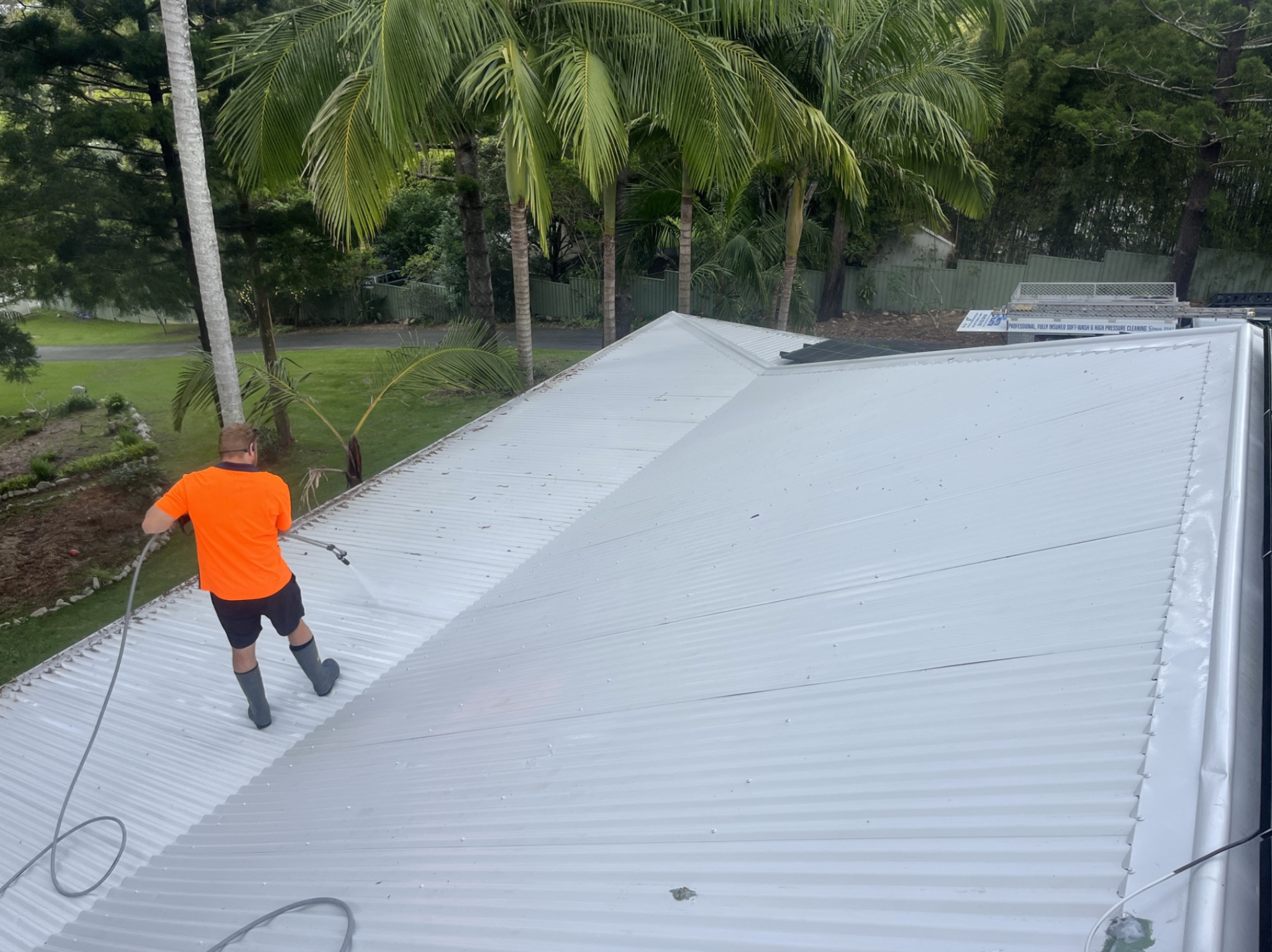 Wally's Master Blaster operator soft washing a Colorbond metal roof
