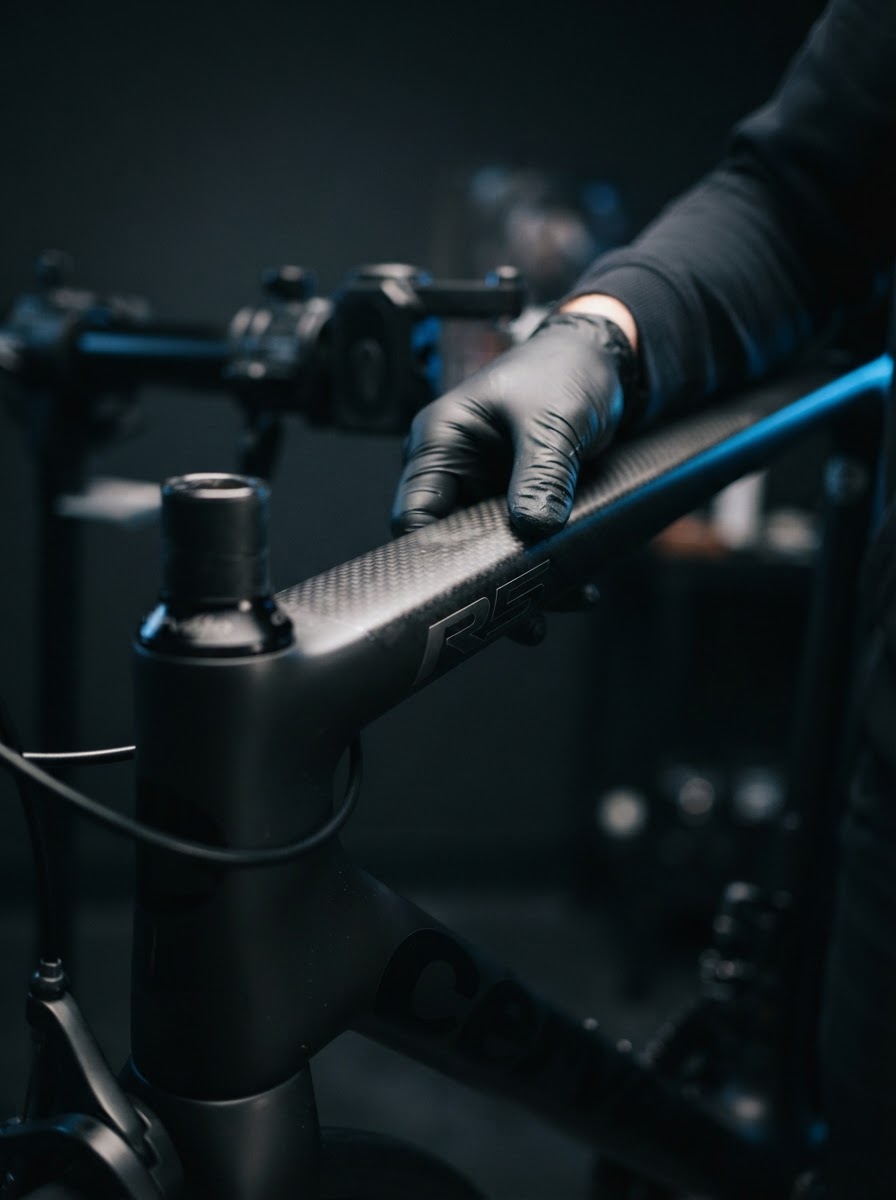 A premium carbon frame being inspected and photographed