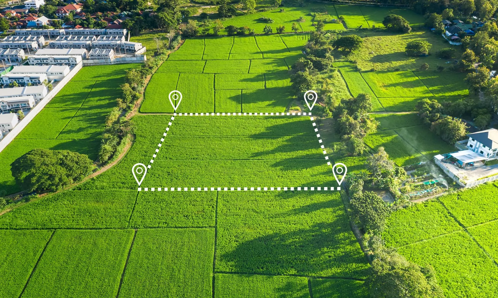 Aerial view of vacant land parcel with boundary pin overlay
