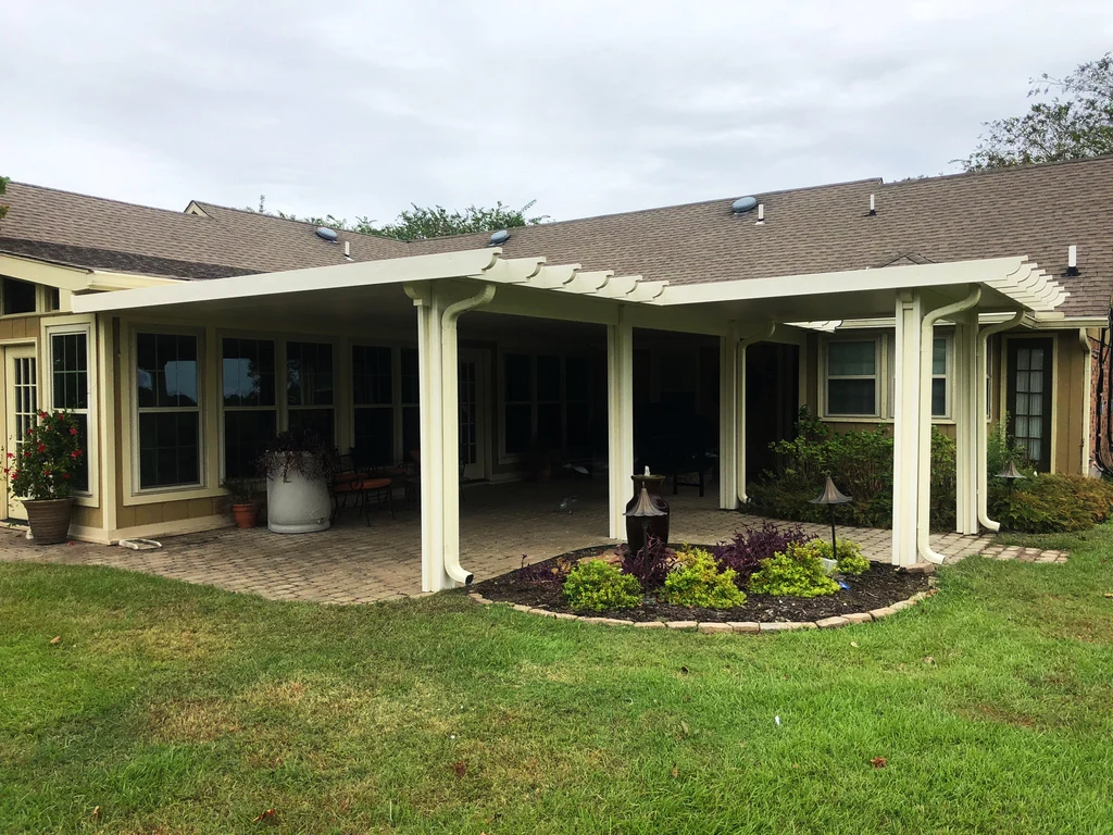 Custom wraparound patio cover installation with integrated drainage