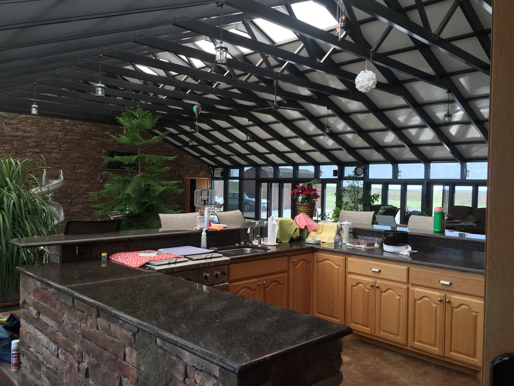 Luxury vaulted ceiling outdoor kitchen and living patio space