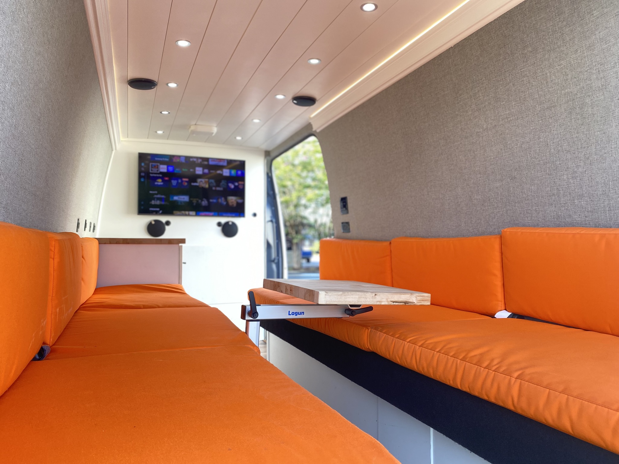Interactive tour of the mobile podcast studio interior showing lounge seating, climate control, power outlets, and connectivity