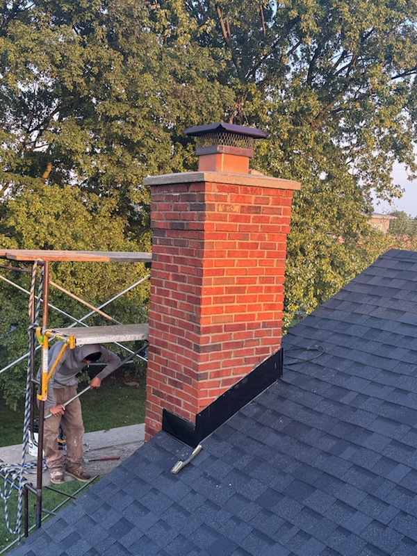 The same chimney rebuilt with a new concrete crown, chimney cap and flashing