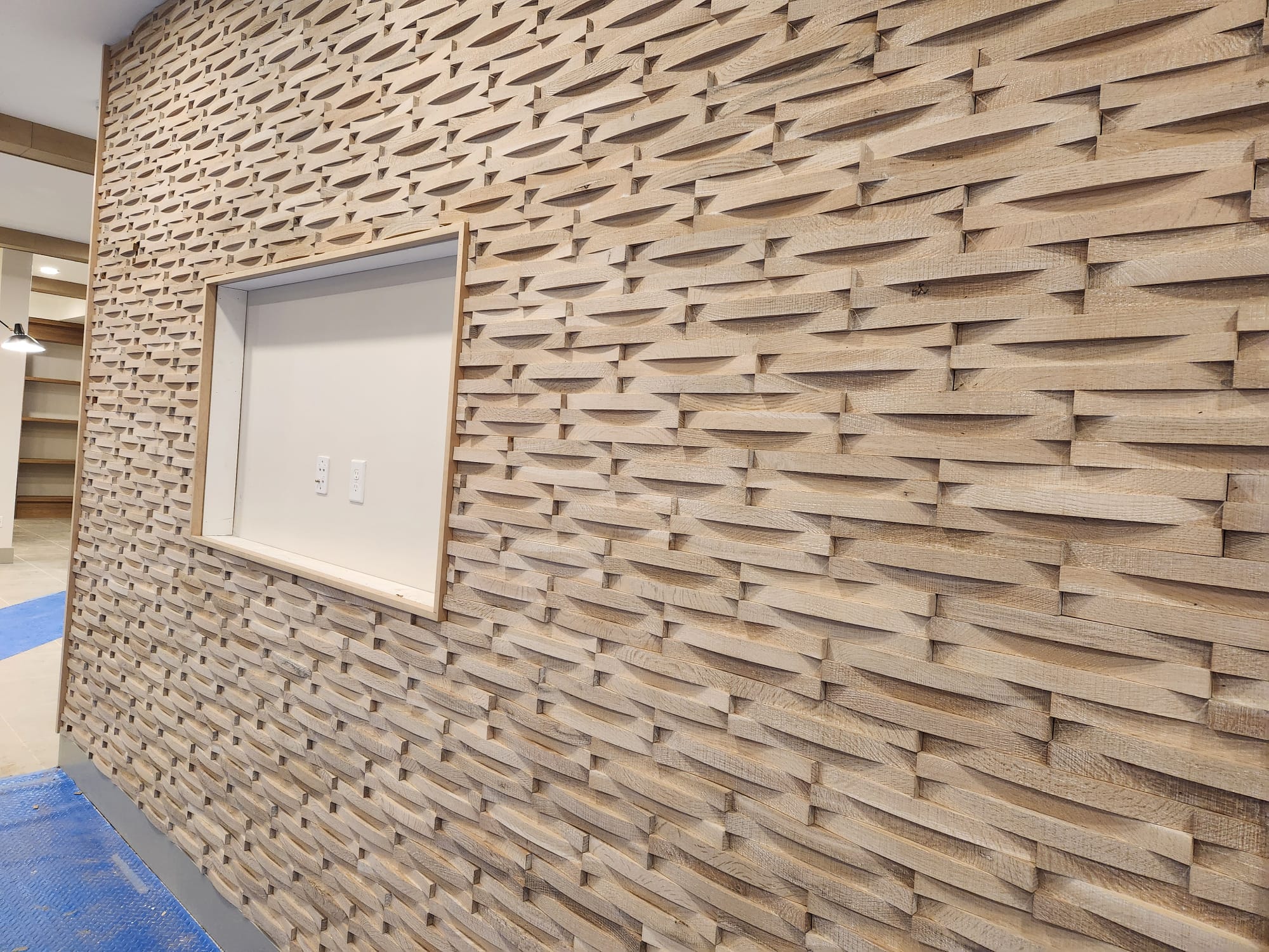 Full wall architectural 3D textured chisel wave hardwood timber cladding with recessed display box in Greensboro NC