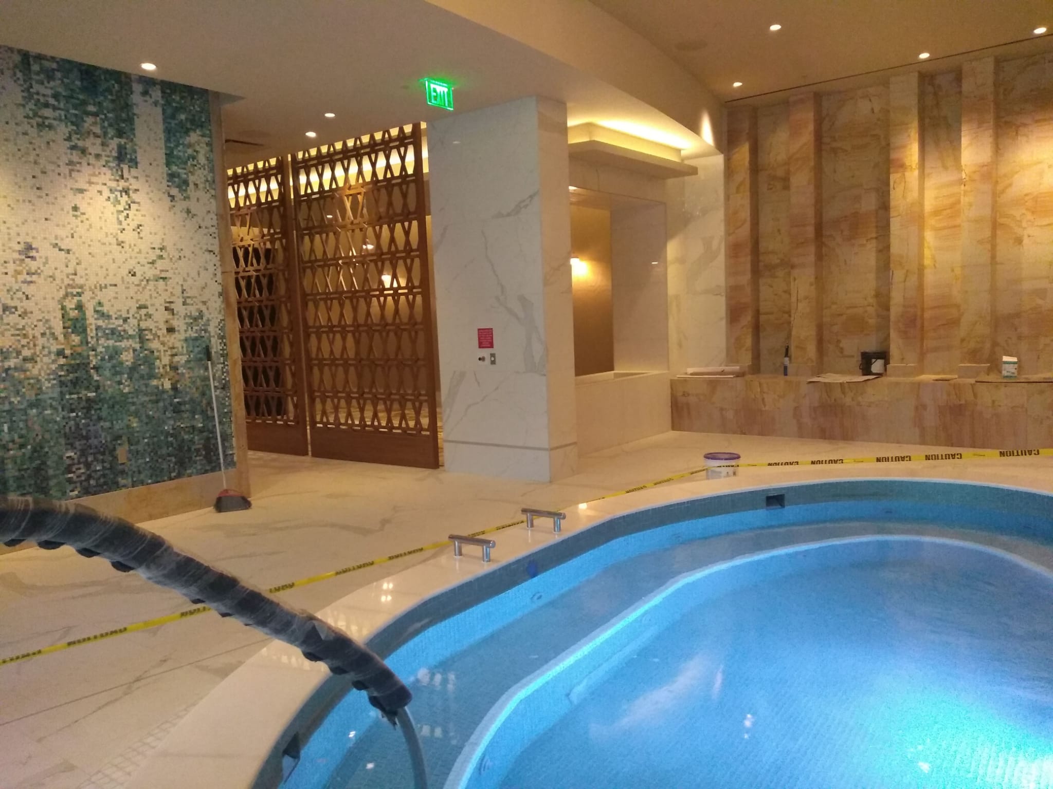 Commercial luxury spa and pool with handcrafted geometric wooden lattice privacy screens in Clemmons NC