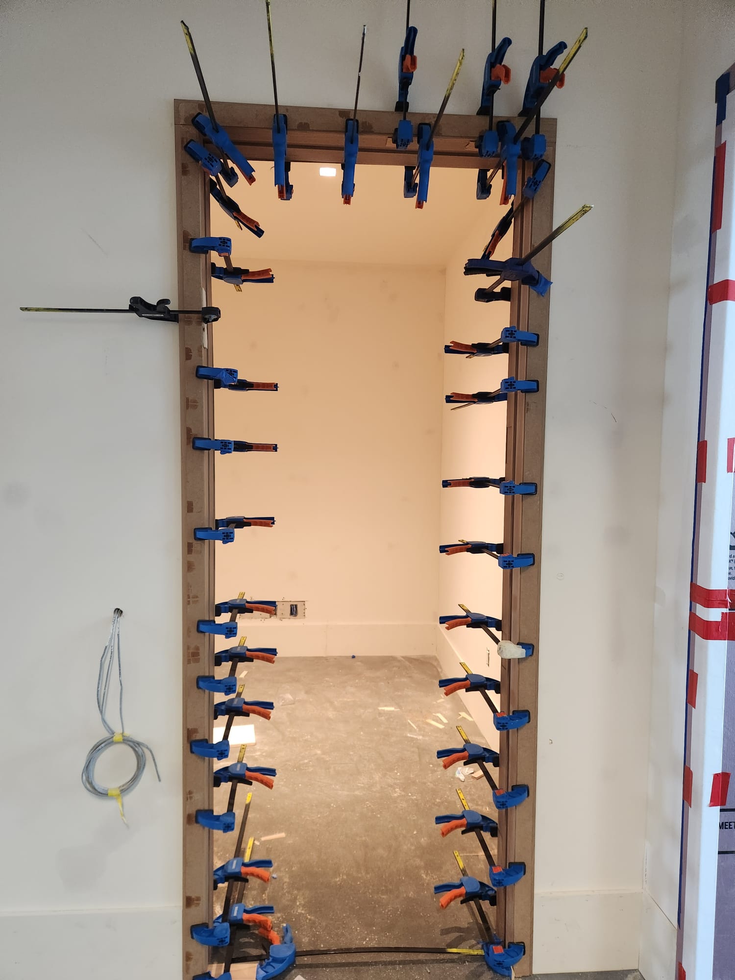 Master finish carpentry door frame casing and trim clamp assembly in progress in Lewisville NC