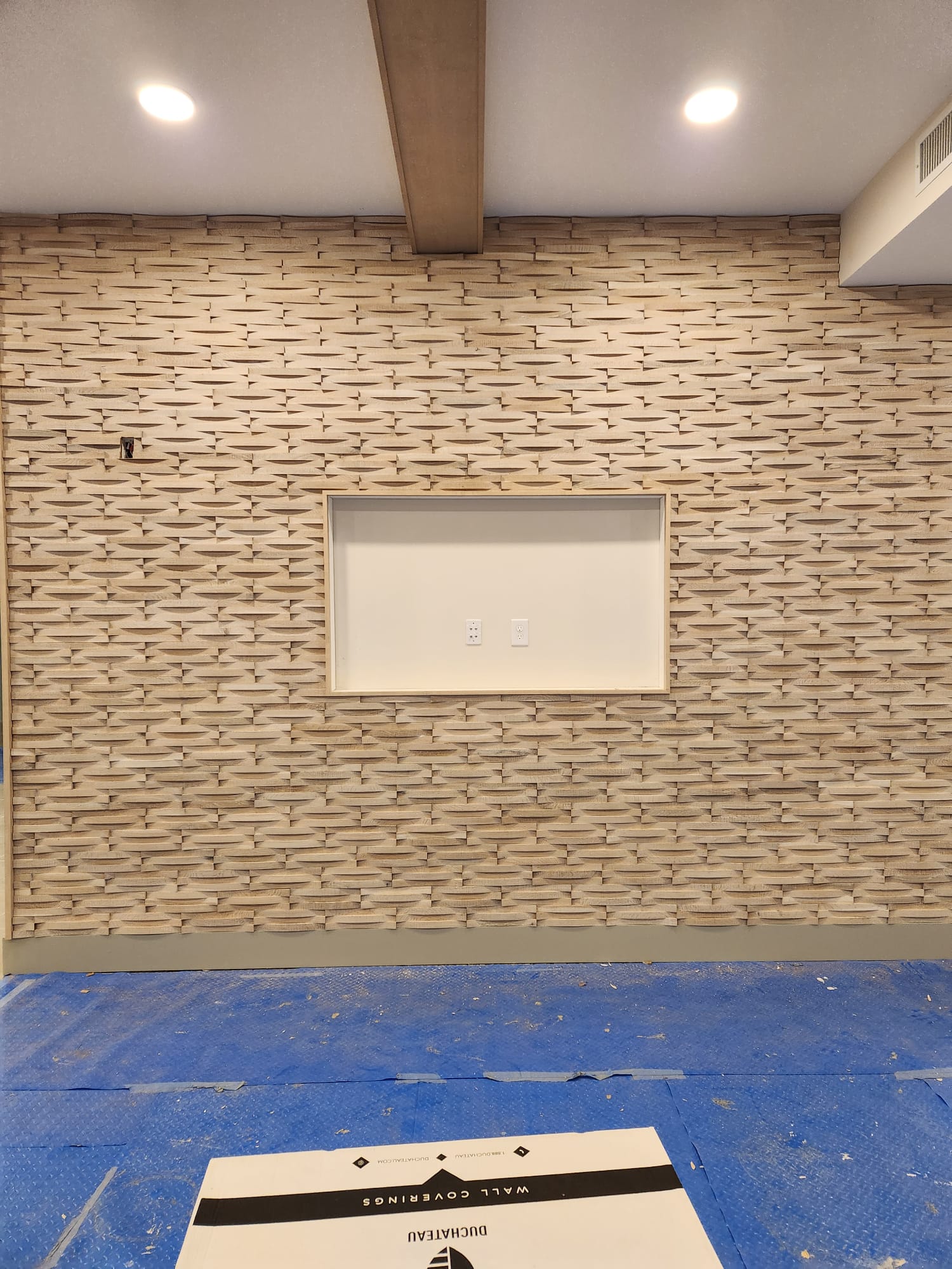 Full wall textured dimensional wood wave paneling with framed recessed display niche in Clemmons NC