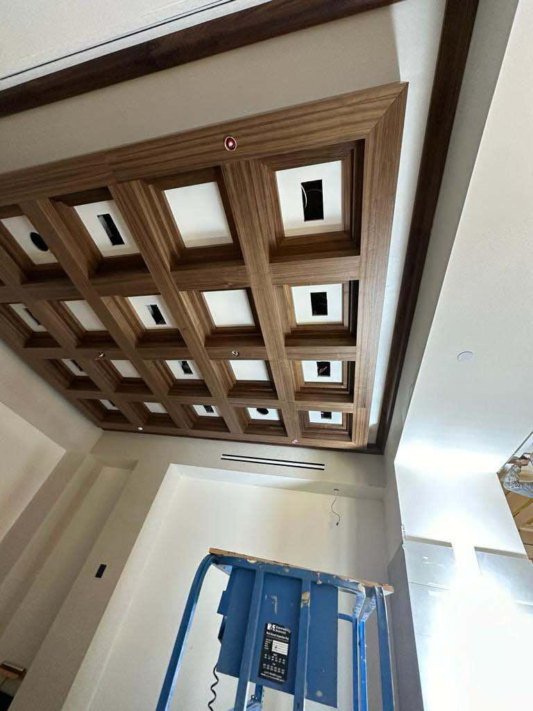 Intricate coffered wood ceiling with recessed square boxes and integrated lighting in Lewisville NC
