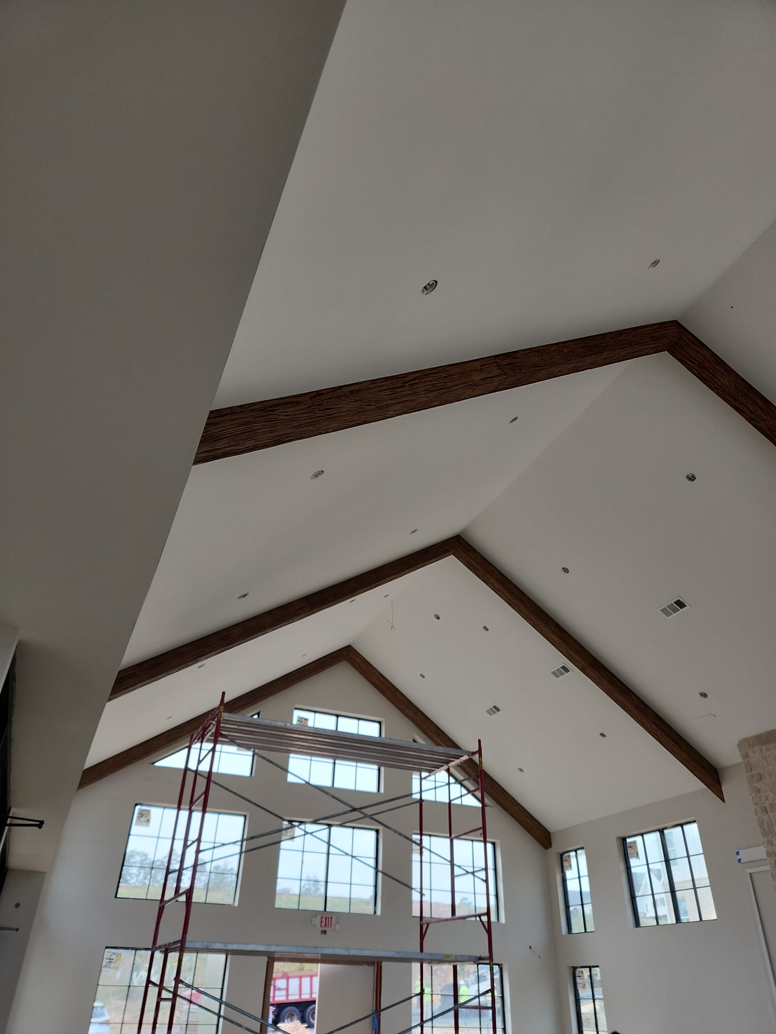 Vaulted apex ceiling with massive dark walnut stained decorative wood rafter beams in Greensboro NC