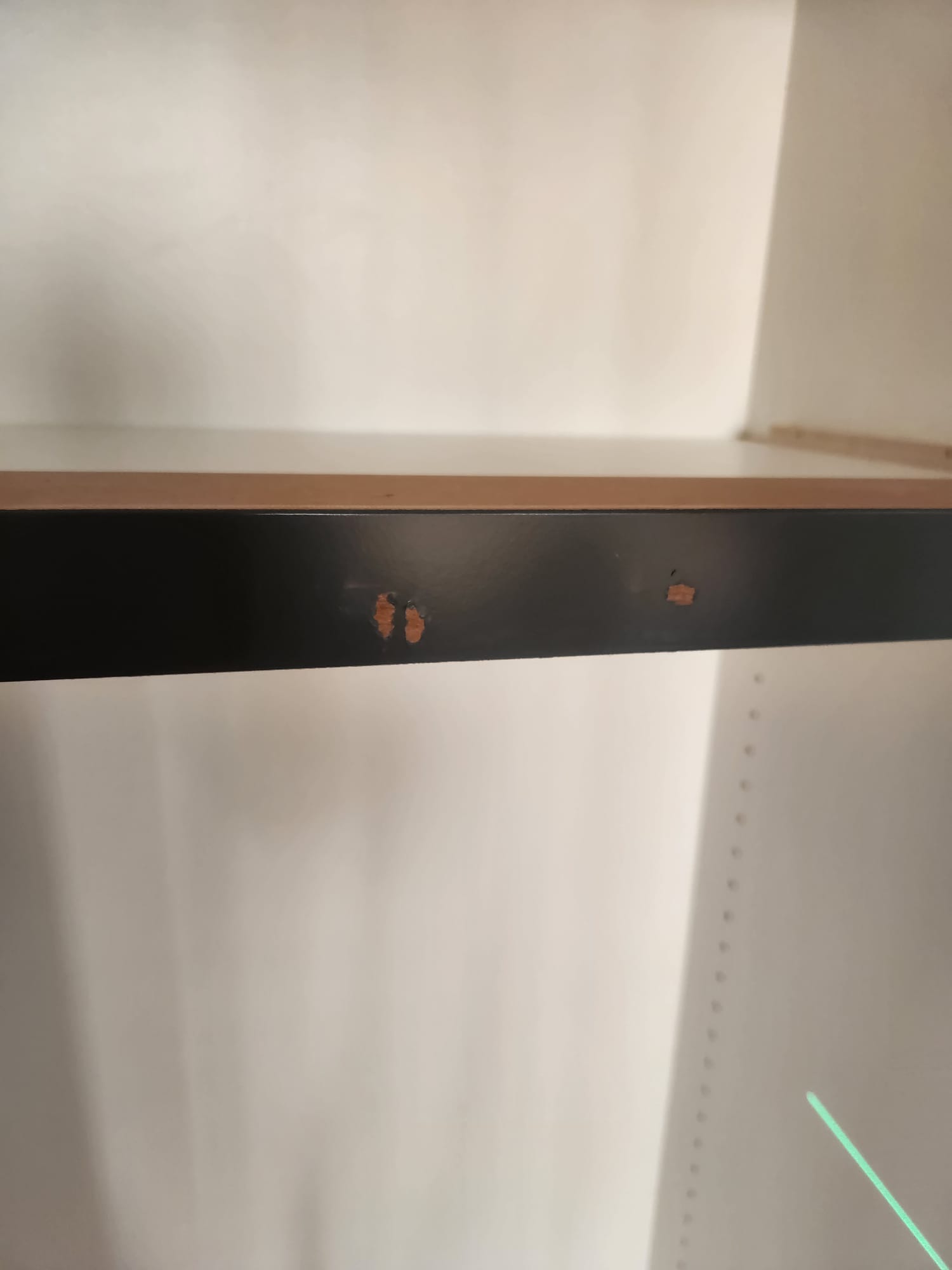 Precision finish carpentry cabinet shelving installation with laser level reference in Clemmons NC