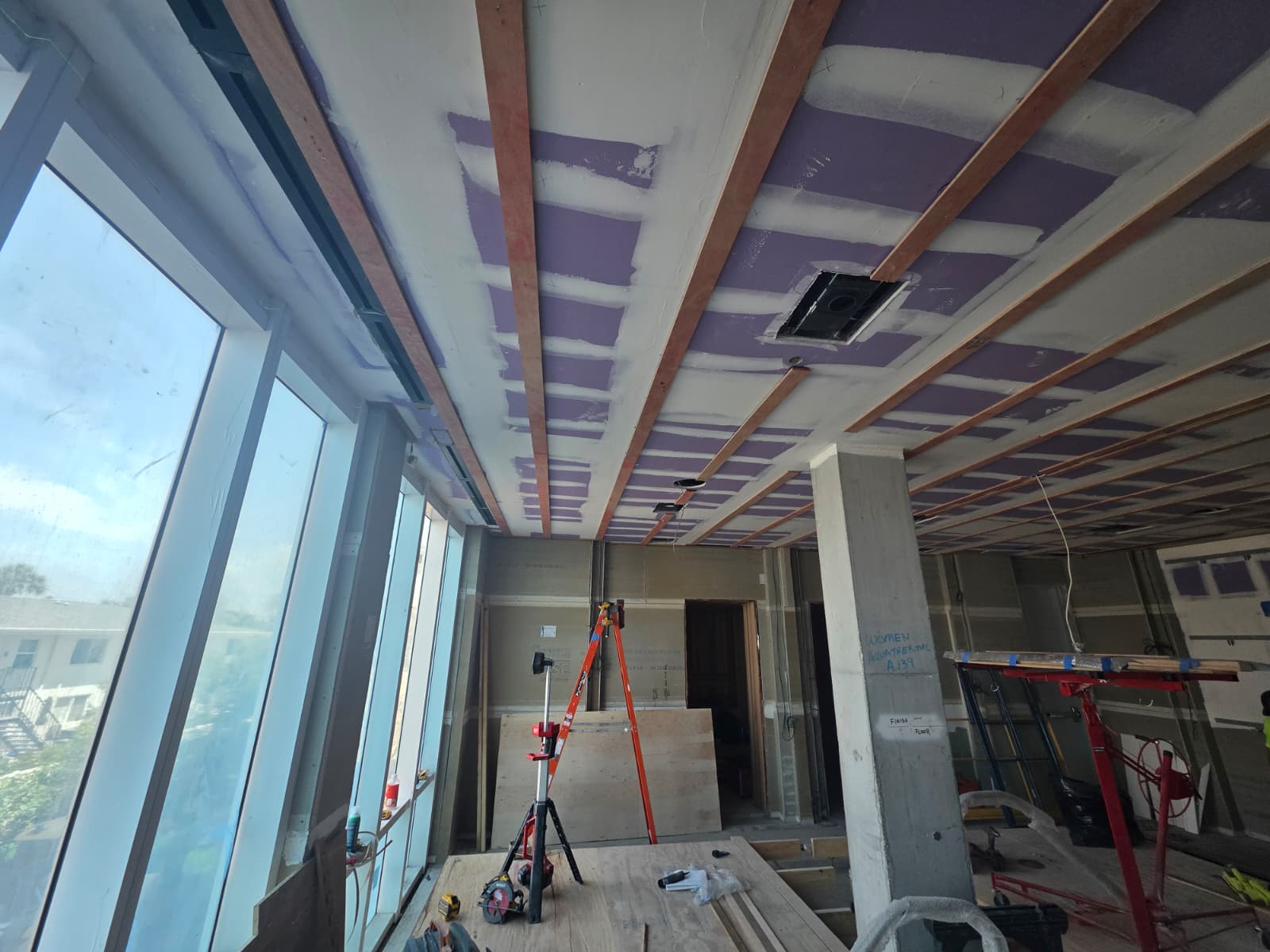 Laser-aligned architectural linear wood ceiling beams under construction in Winston-Salem NC commercial space
