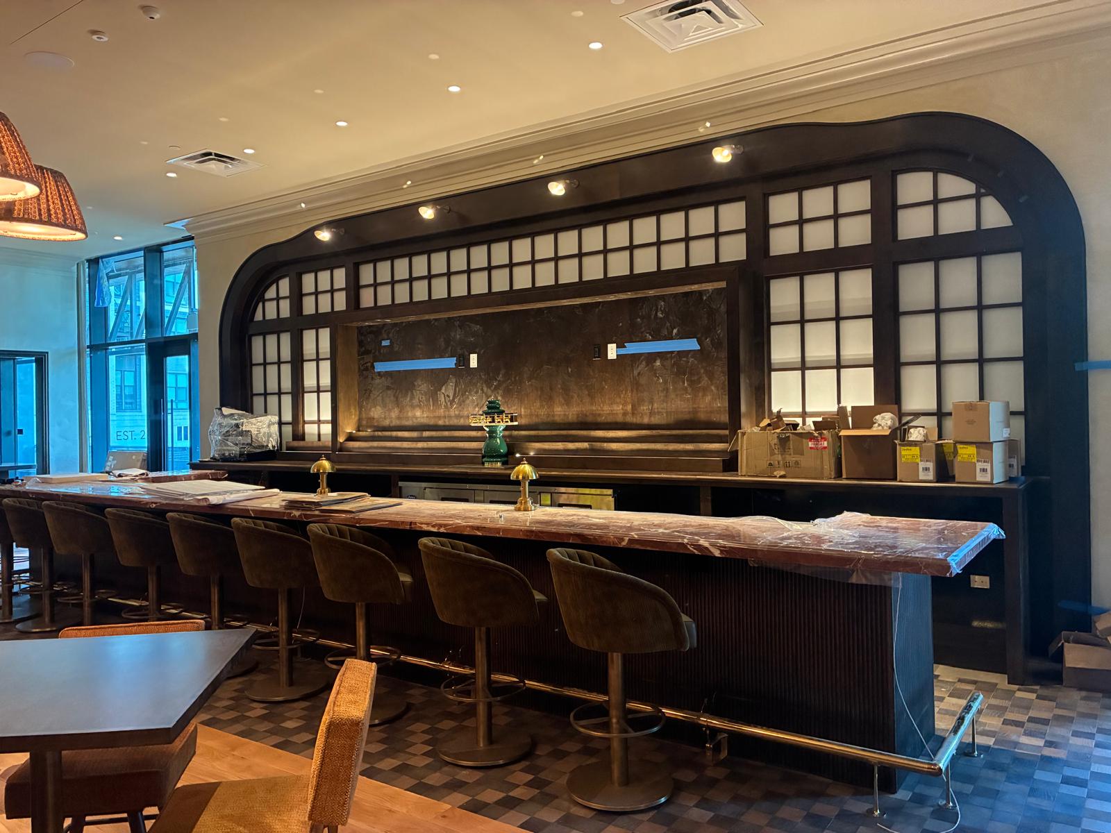 Custom arched architectural bar woodwork, grid wood backdrop, and fluted bar front in Winston-Salem NC