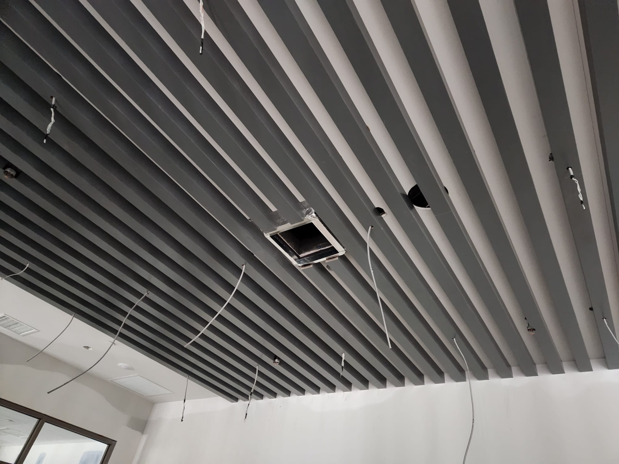 Linear architectural timber ceiling baffles with precision electrical and lighting cutouts in Winston-Salem NC