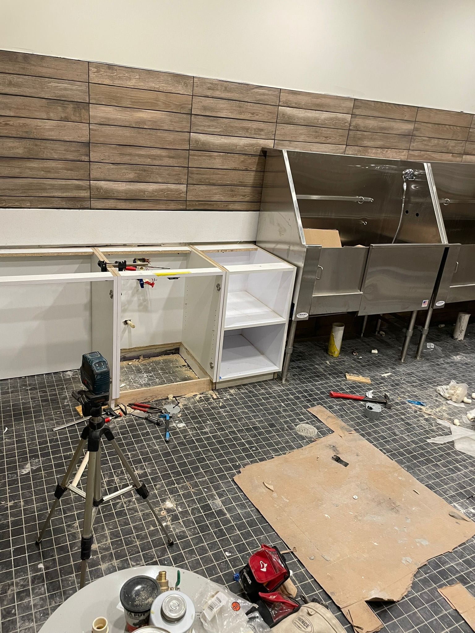 Commercial finish carpentry base cabinet installation with laser level alignment in Lewisville NC