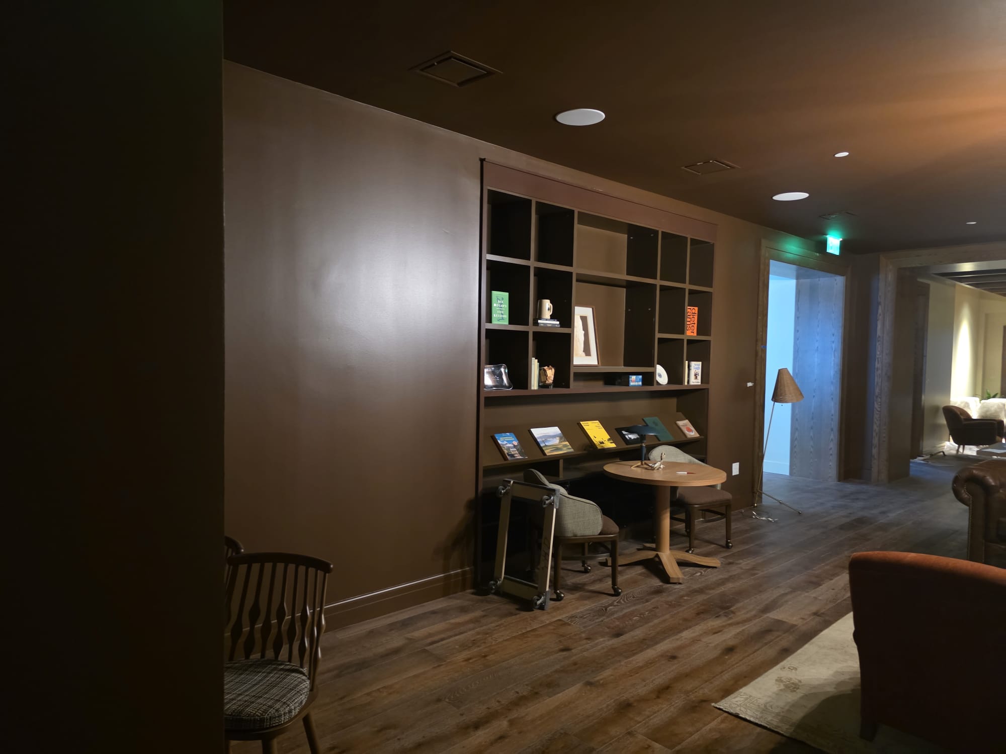 Built-in library shelving unit with display cubbies and wide plank hardwood floors in Lewisville NC