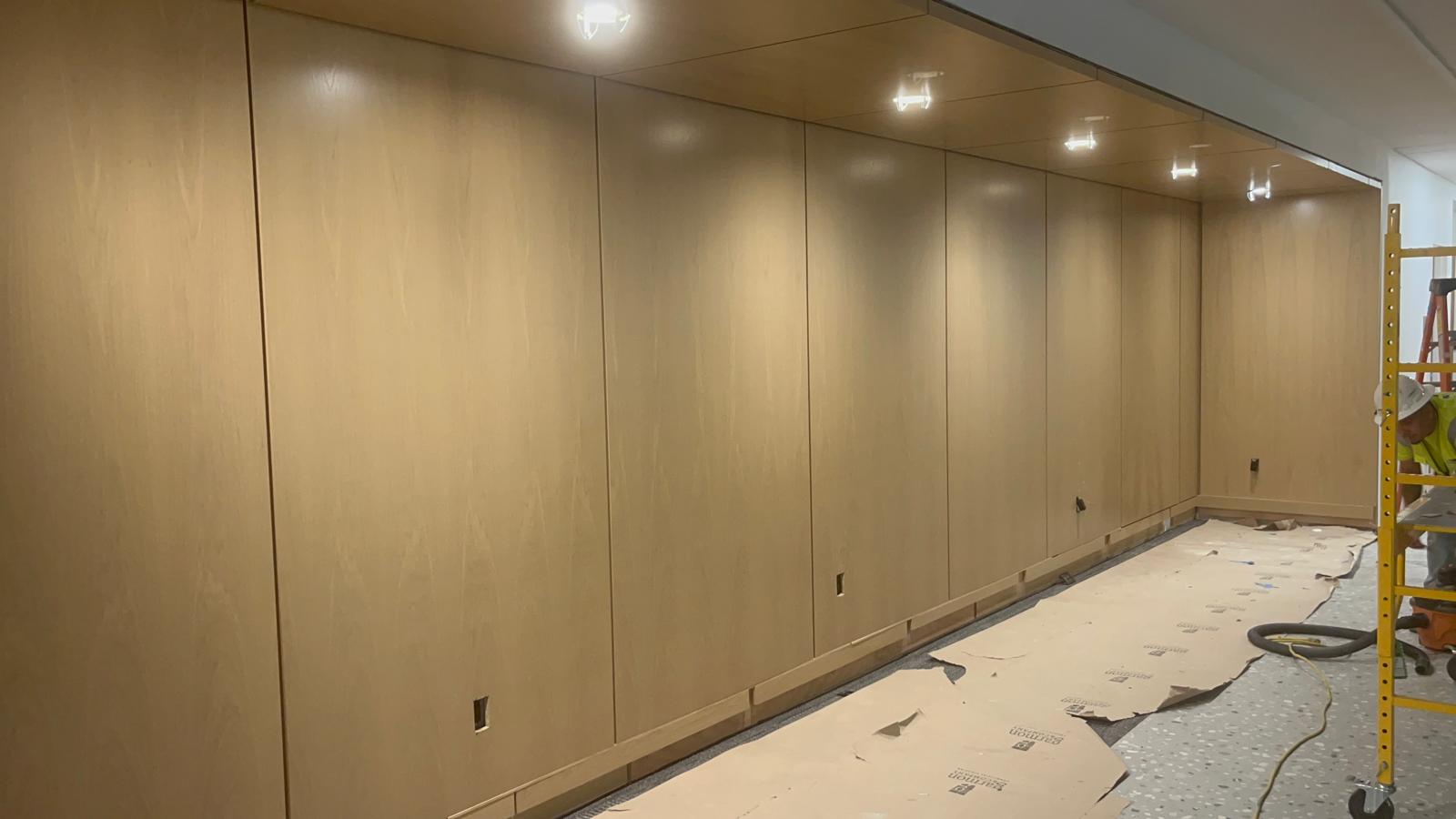 Full height flat wood wall paneling and overhead recessed light canopy installed in Greensboro NC