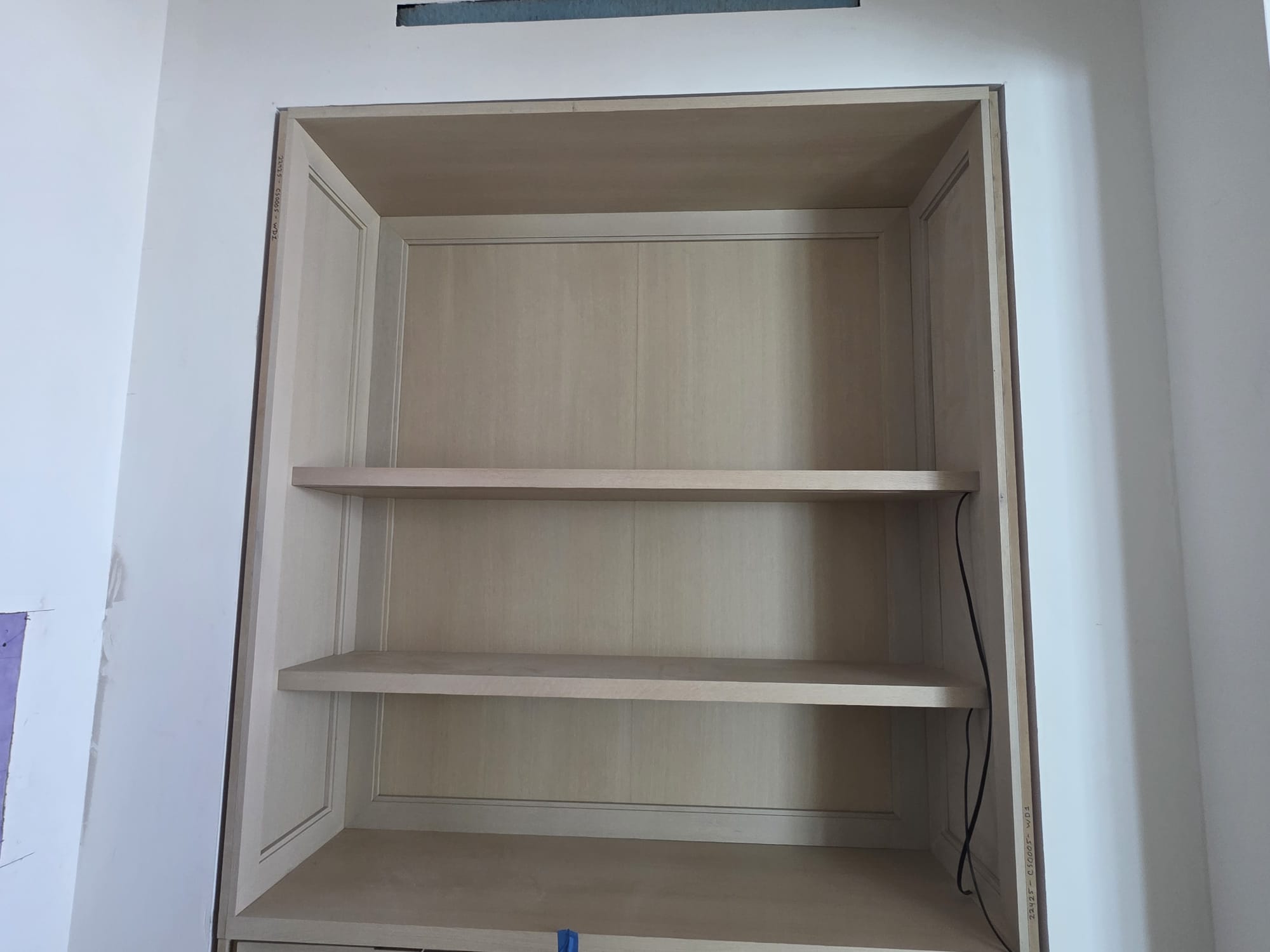 Custom built-in recessed wood shelving display niche with framed casing installed in Lewisville NC
