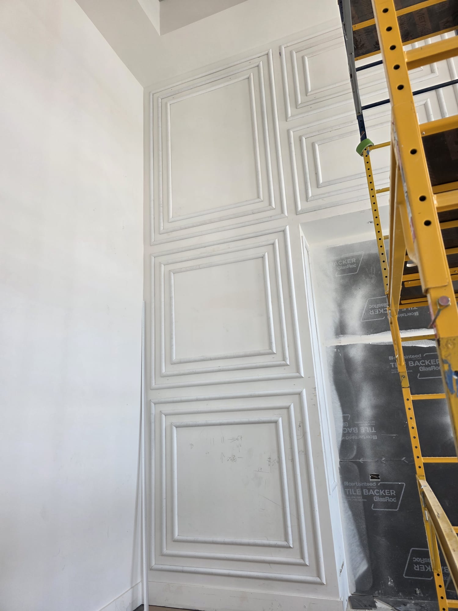 Multi-tiered picture frame shadow box wall molding on high ceiling accent wall in Greensboro NC