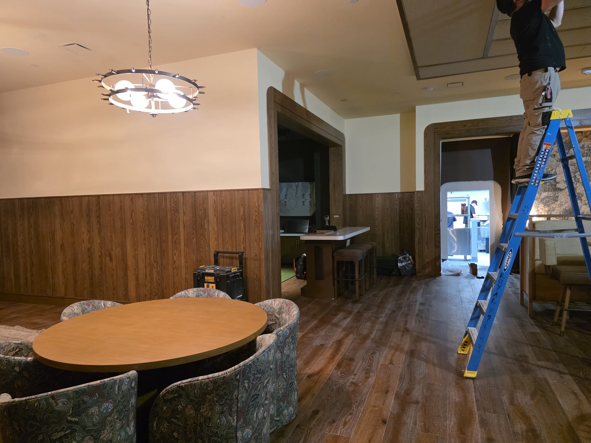 Vertical wood plank wainscoting and grand cased archways in luxury Winston-Salem dining space