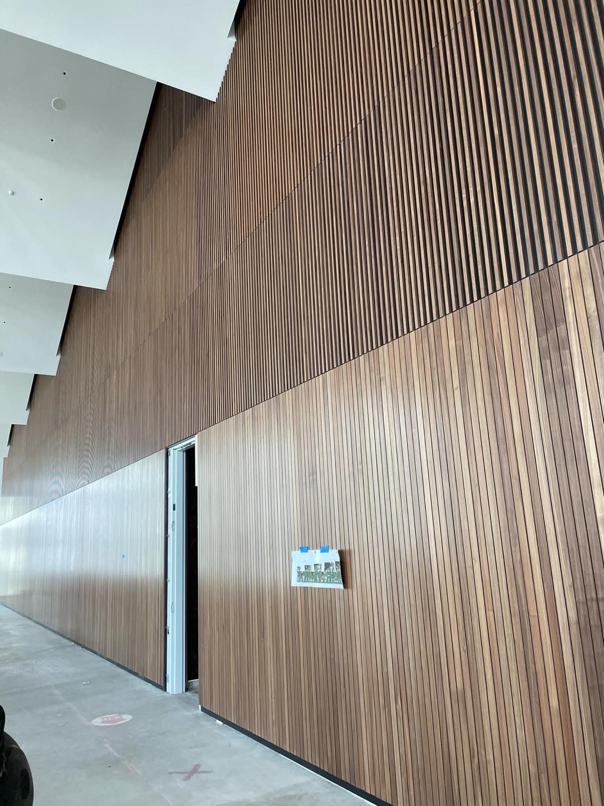 Full-height vertical architectural wood slat wall installation completed by Crafted Wood & Trim in Winston-Salem NC