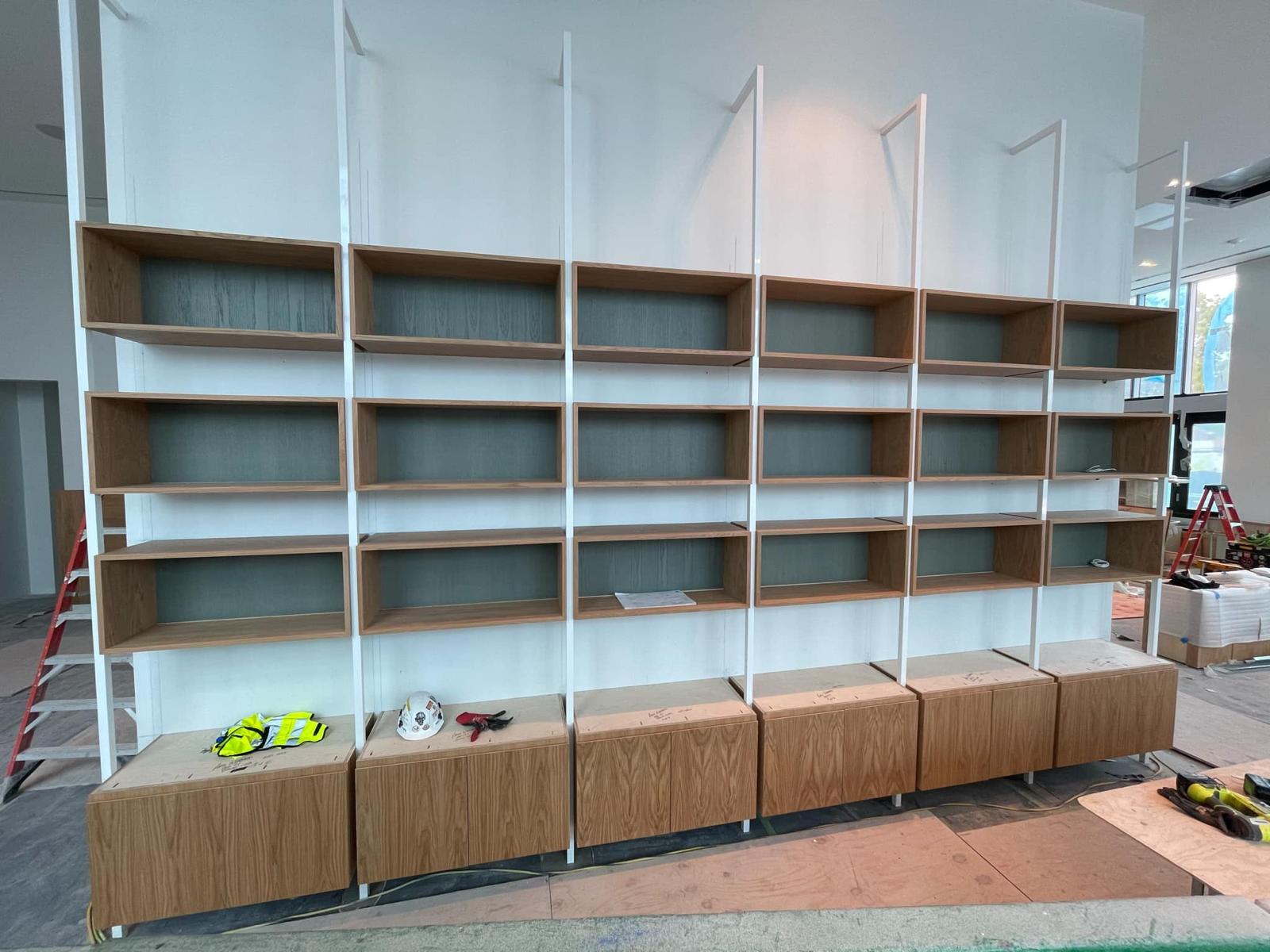 Custom built-in wood display boxes with metal framing and base storage in Lewisville NC
