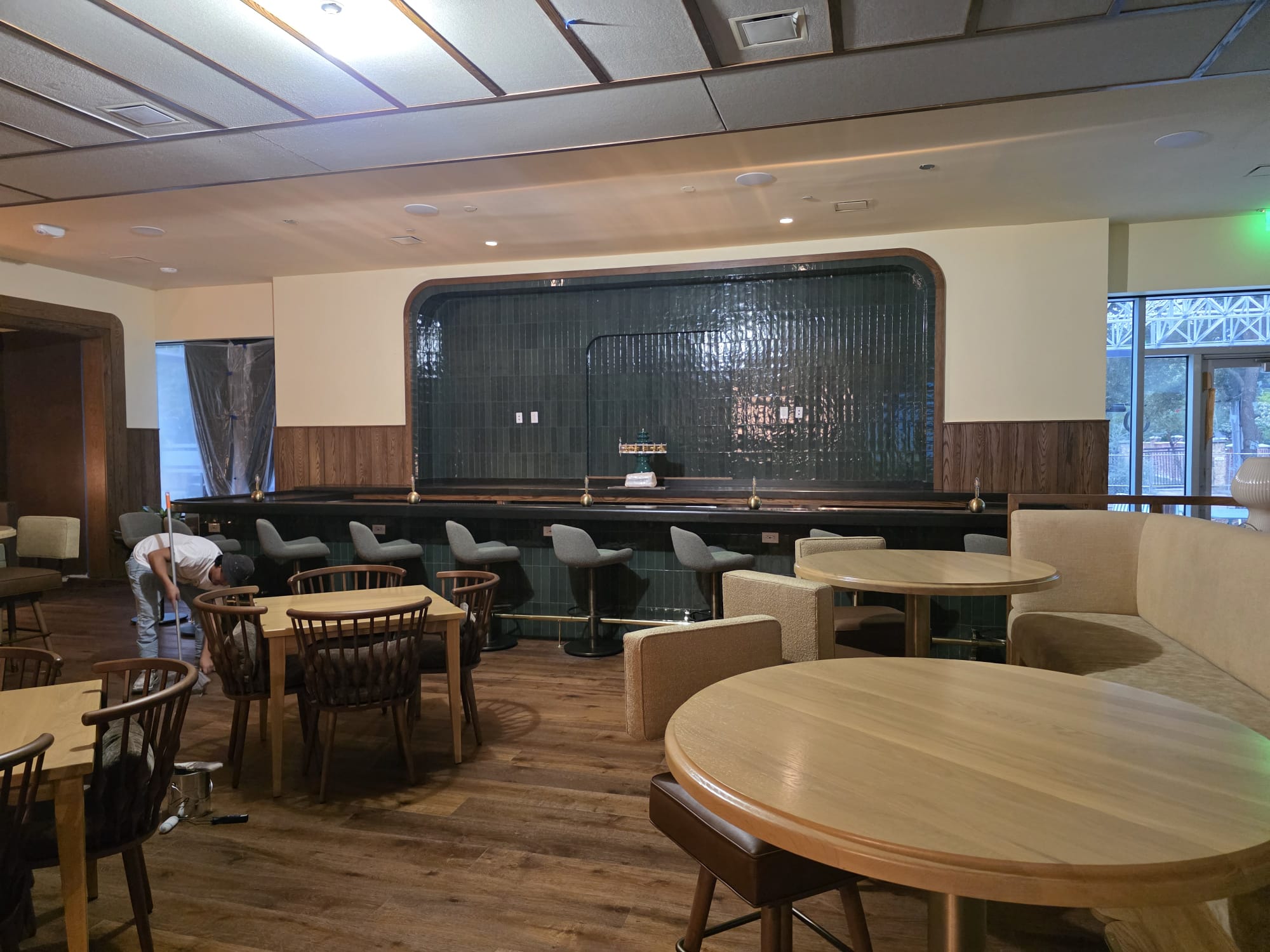 Commercial dining lounge bar with custom arched tile alcove, wood wainscot paneling, and hardwood tables in Winston-Salem NC
