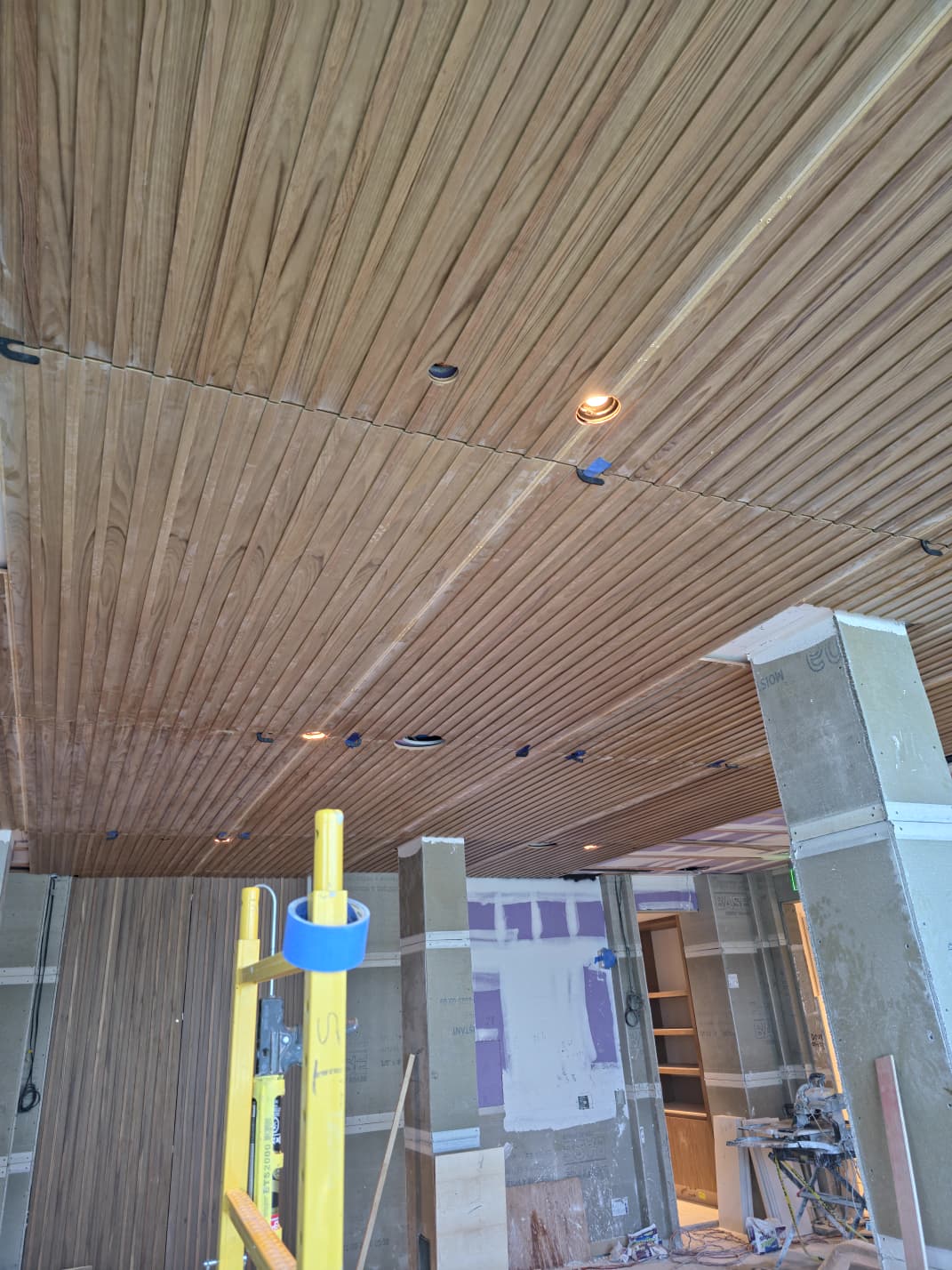 Linear wood slat ceiling plank installation with precision lighting recesses in Winston-Salem NC