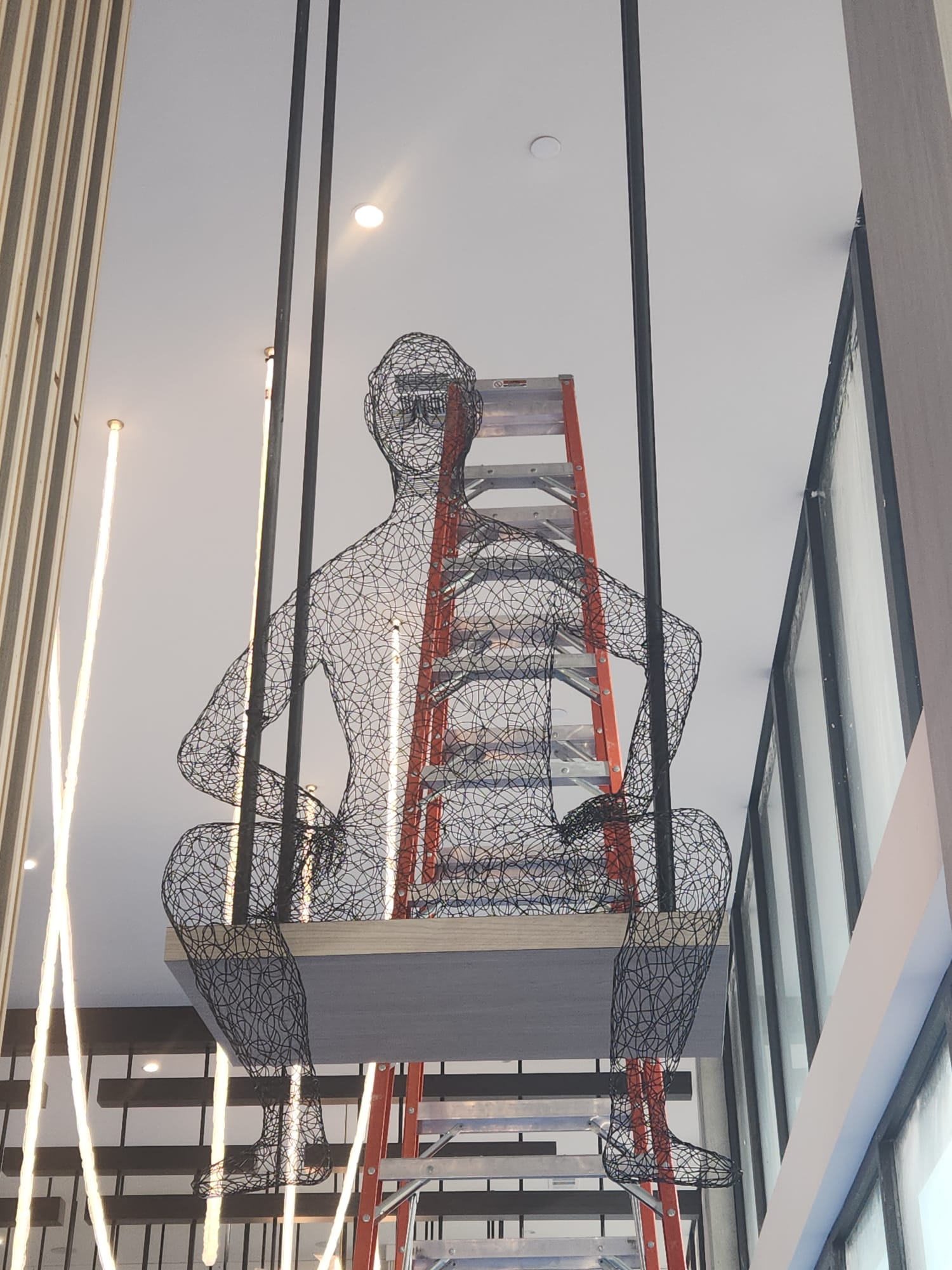 Custom steel cable suspended timber swing platform installation in high-ceiling Winston-Salem commercial venue