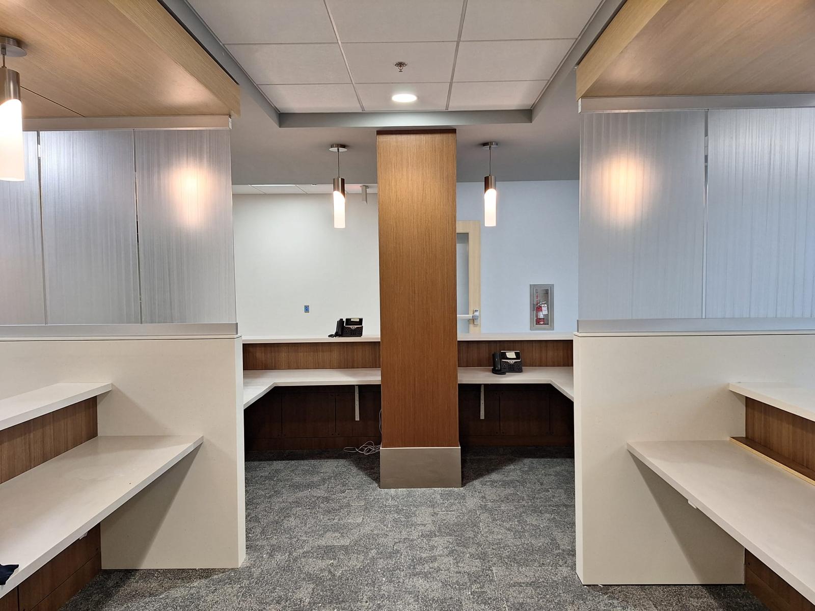 Custom commercial dual reception desks with wood wrapped structural column in Clemmons NC