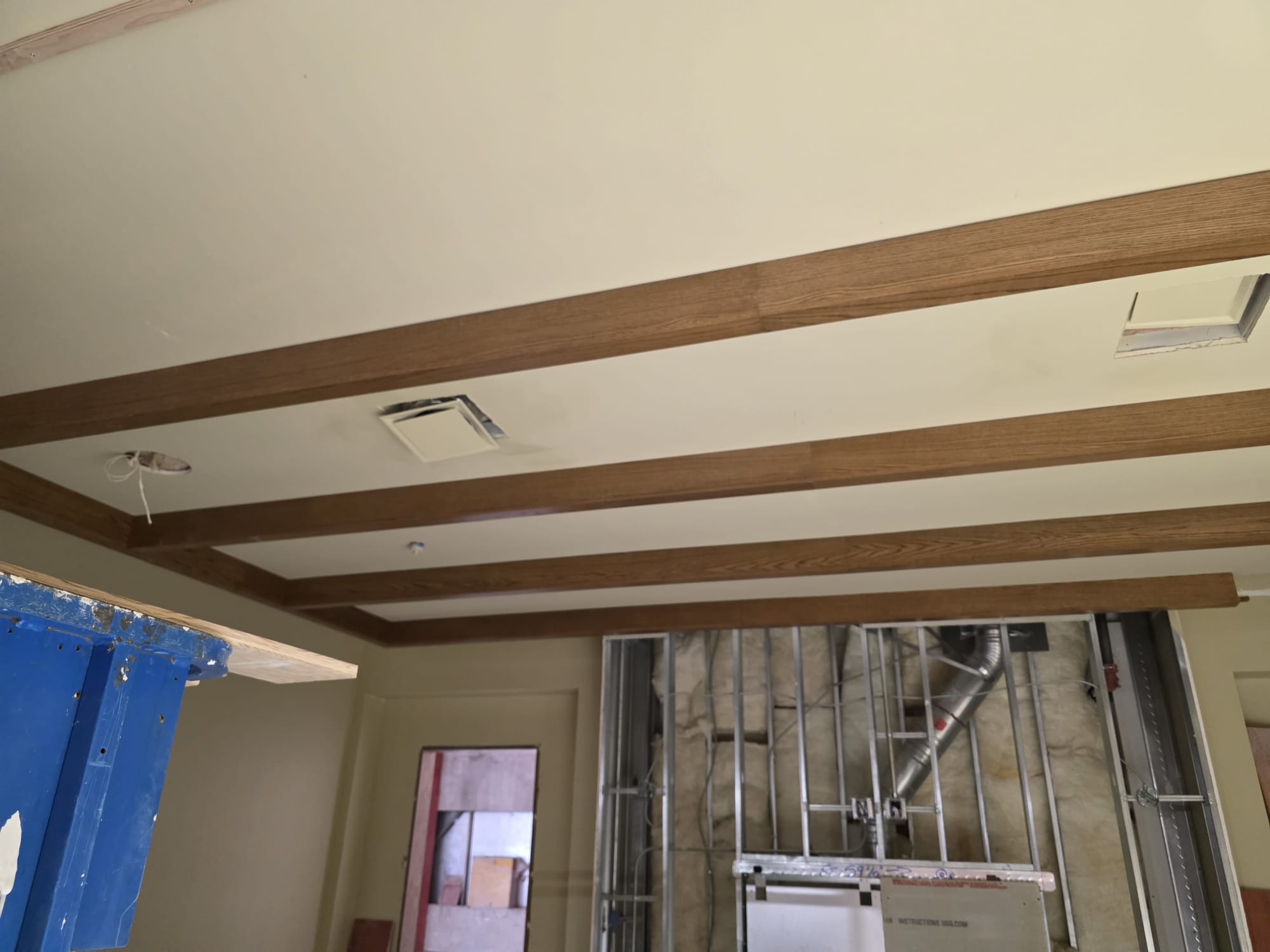 Hardwood stained parallel ceiling box beams and perimeter crown trim installed in Clemmons NC