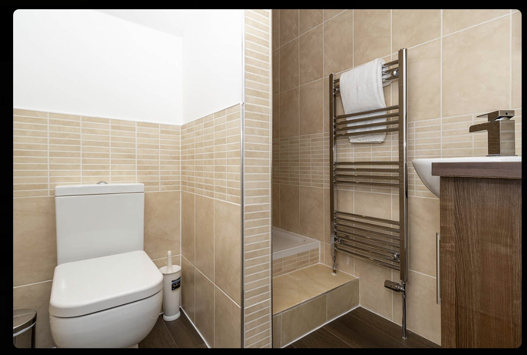 Modern tiled bathroom with heated towel rail at The Residences Aberdeen