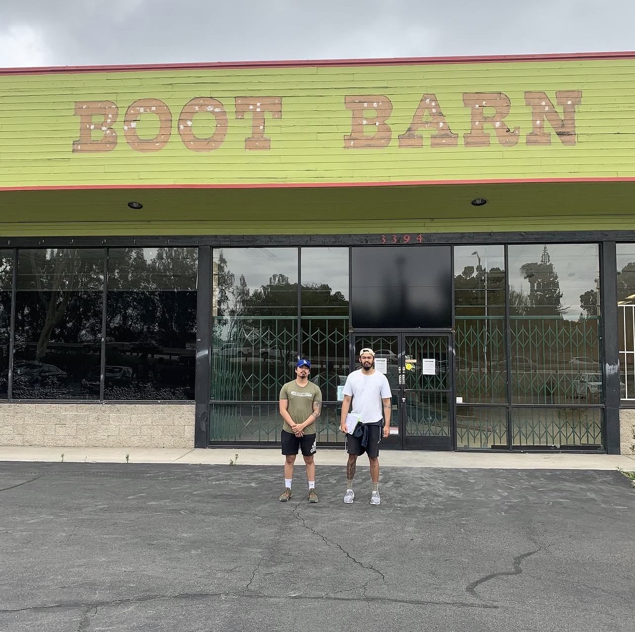 Chris Aumentado (left) and Erickson Aumentado (right) standing in front of the original Boot Barn building at 3394 — where MBSP was born