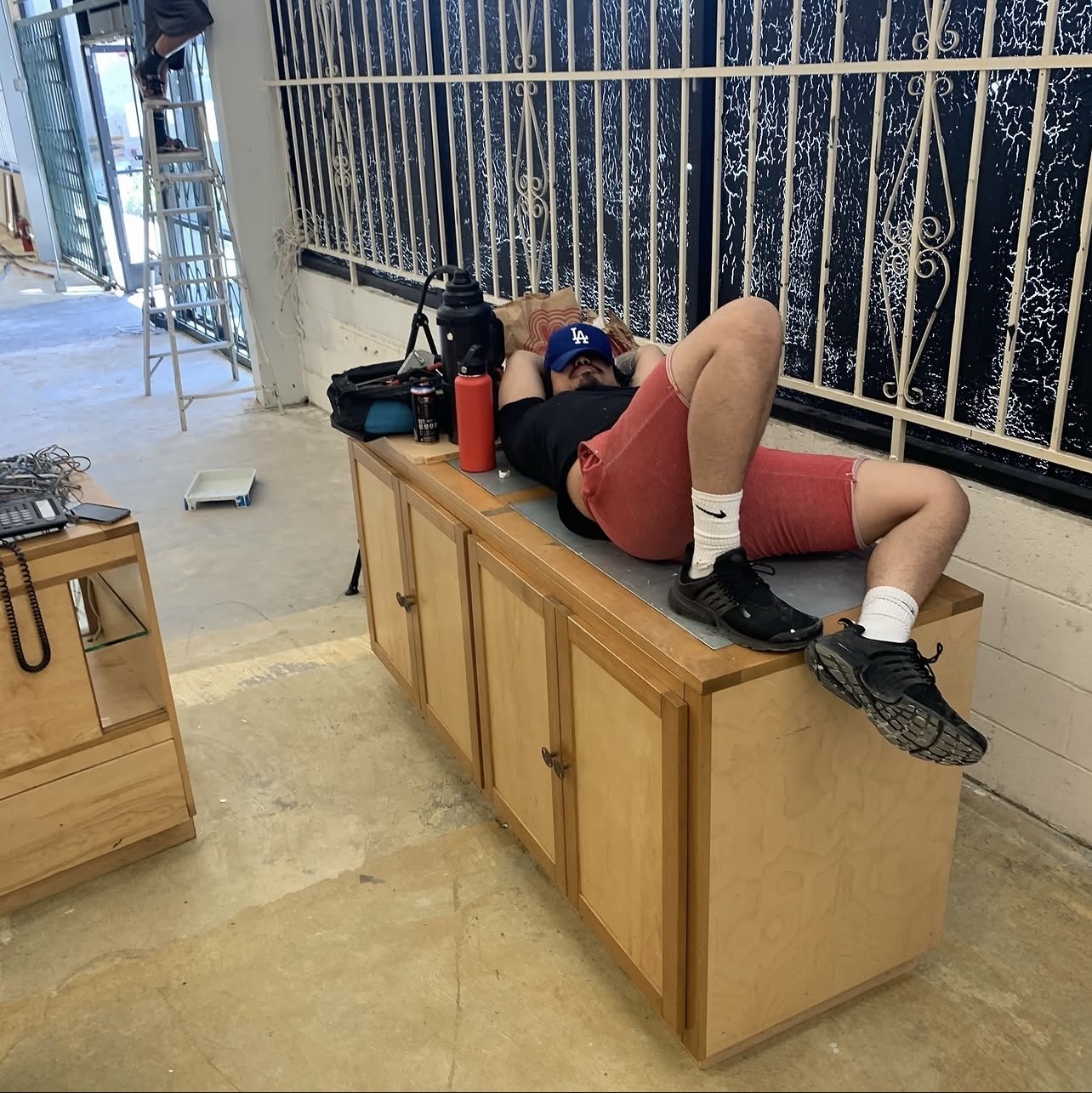 Exhausted during the gym renovation build-out — the grind behind the glamour