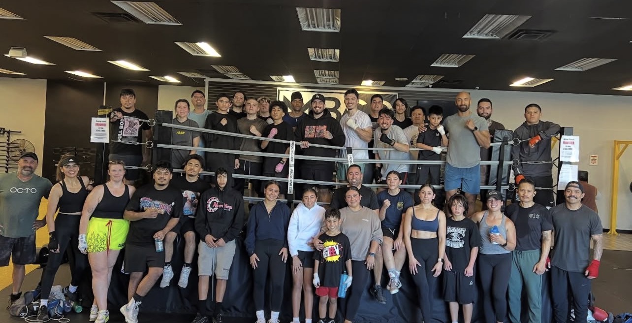 MBSP full community group photo — members, coaches, and athletes of all levels together inside the Riverside gym