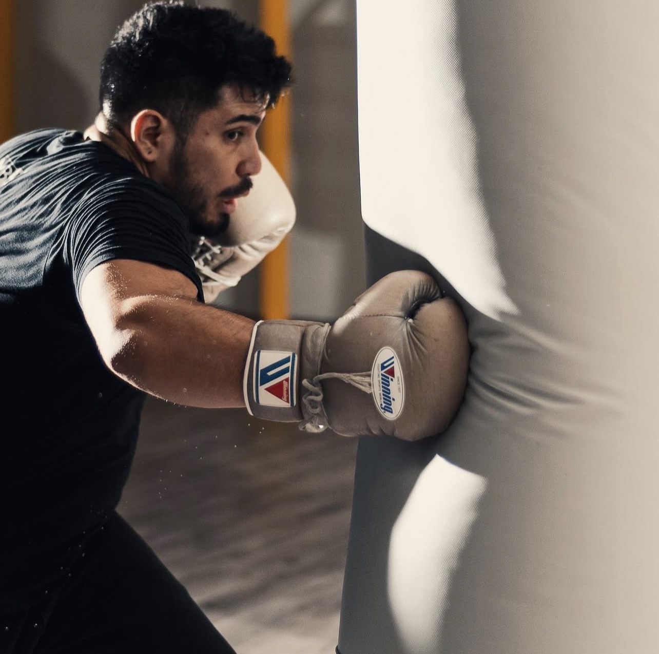 MBSP athlete training with boxing gloves on the heavy bag — technical precision in action