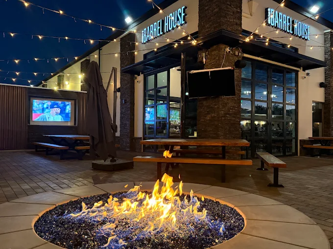 Outdoor patio with roaring fire pit, outdoor TVs, and seating